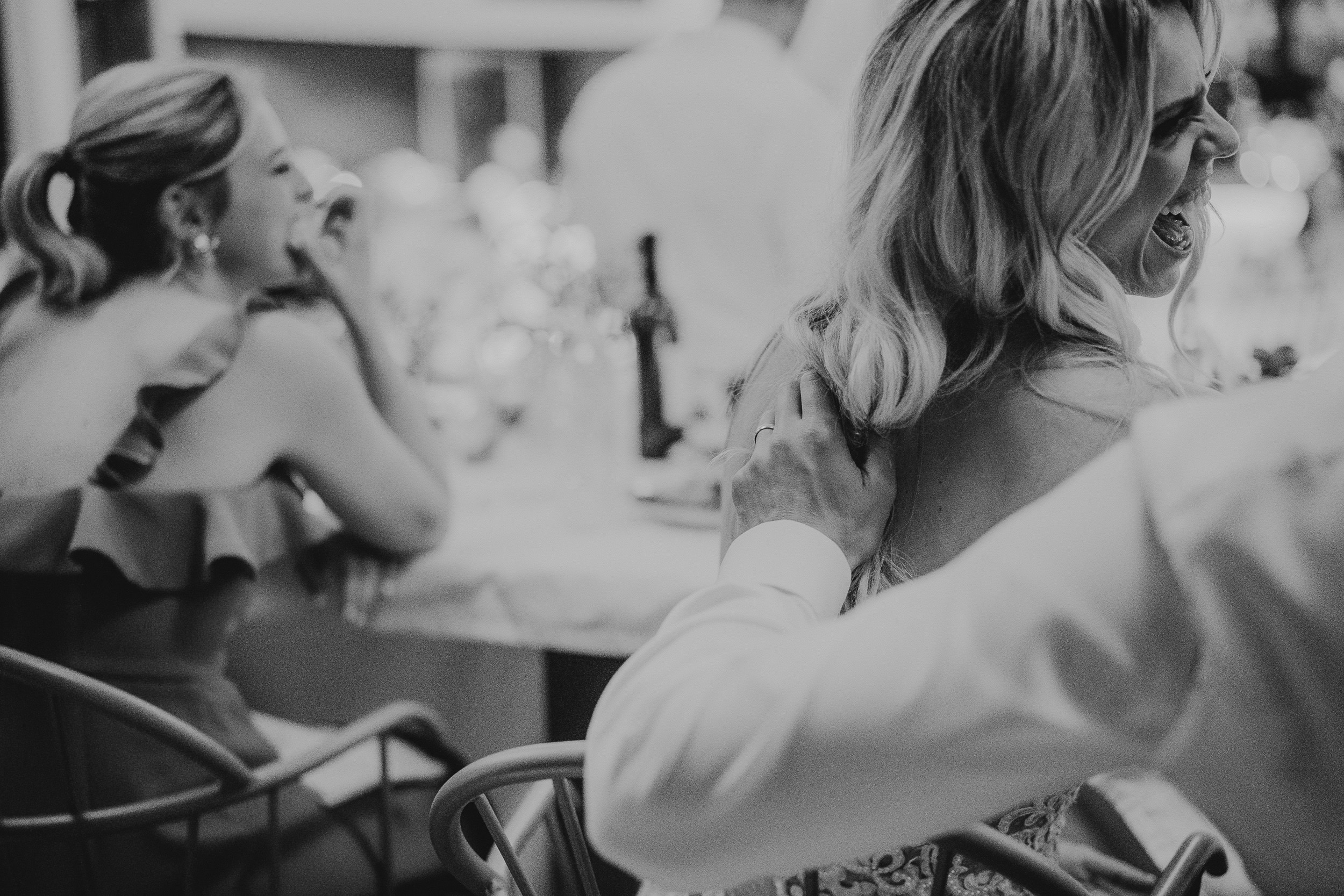 Wedding photographer captures a tender moment between bride and groom in a black and white photo.