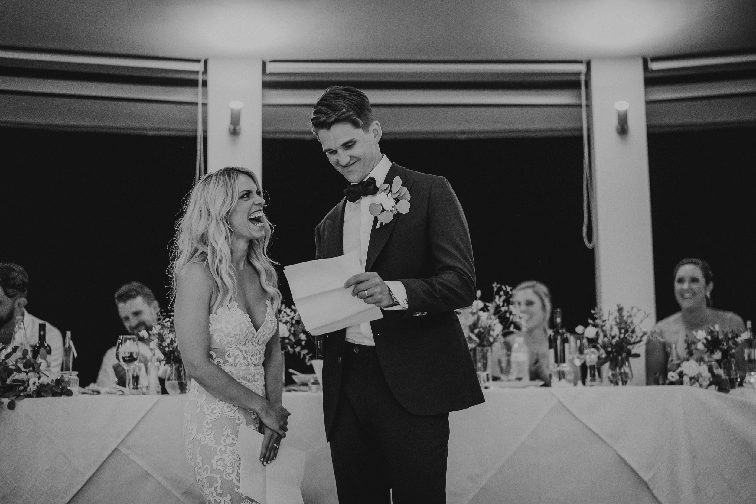 A groom and bride exchanging vows at their wedding reception.