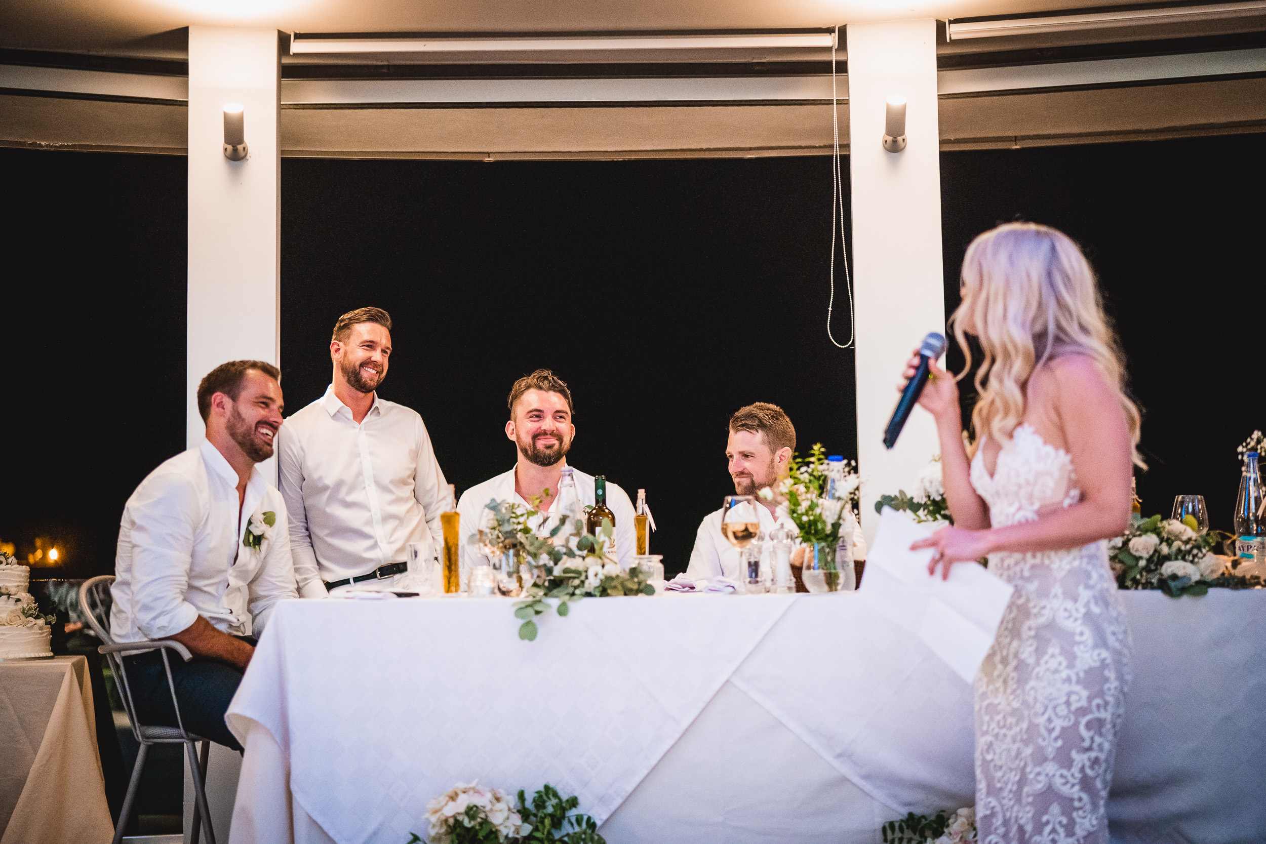 A bride giving a heartfelt speech at her wedding reception, captured by the talented wedding photographer.