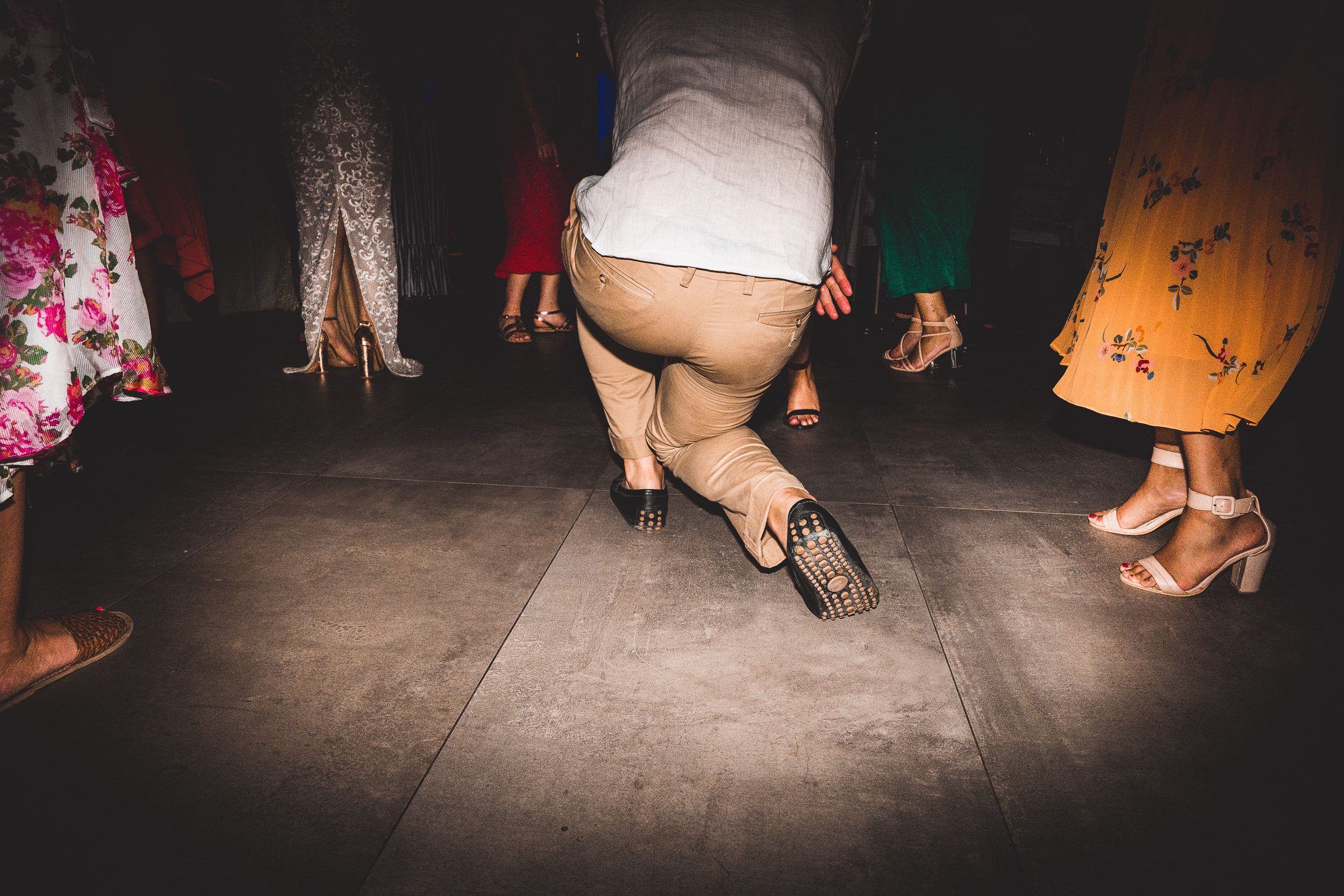 A wedding party dancing in a dark room.