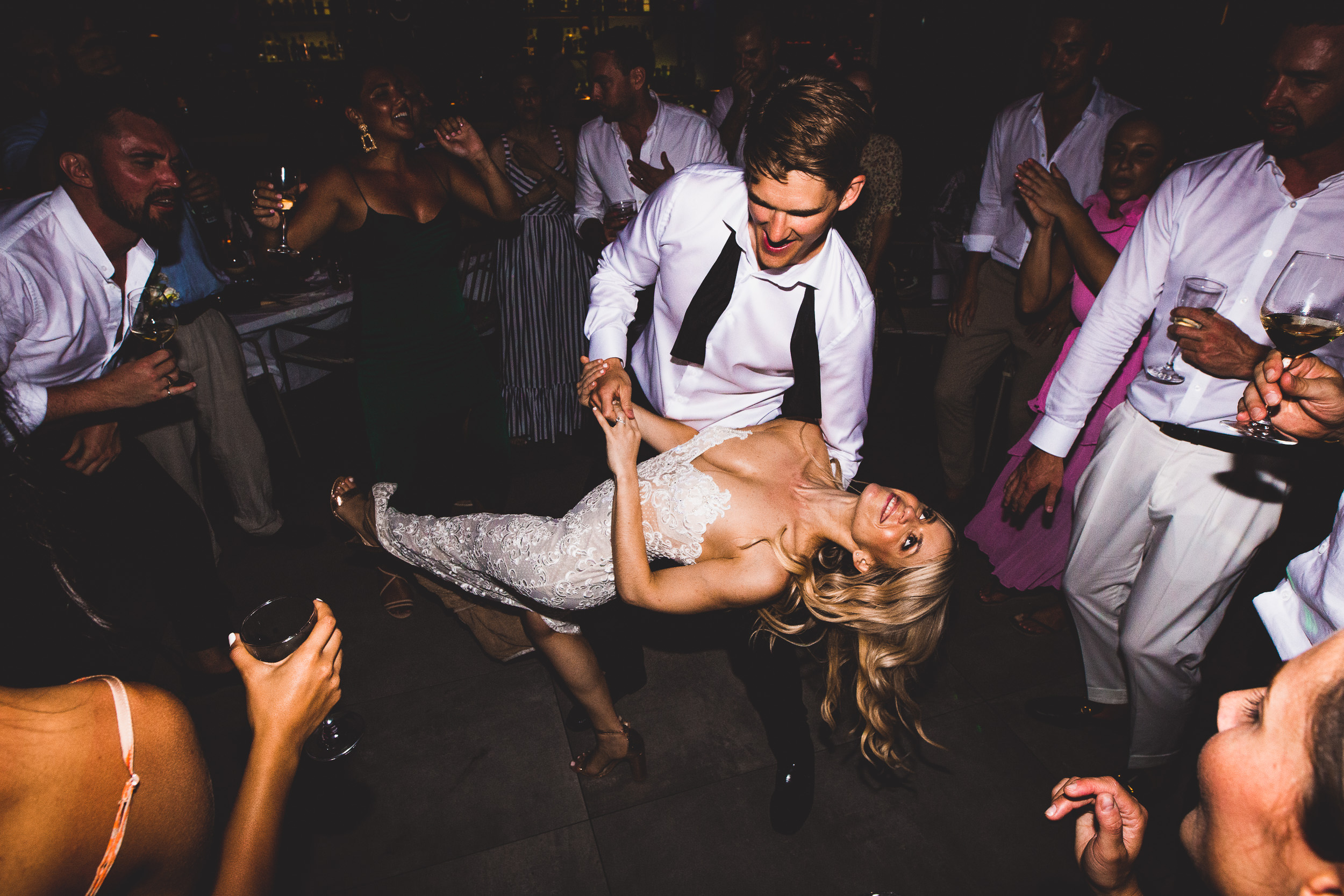 A groom and bride dancing at a wedding reception.