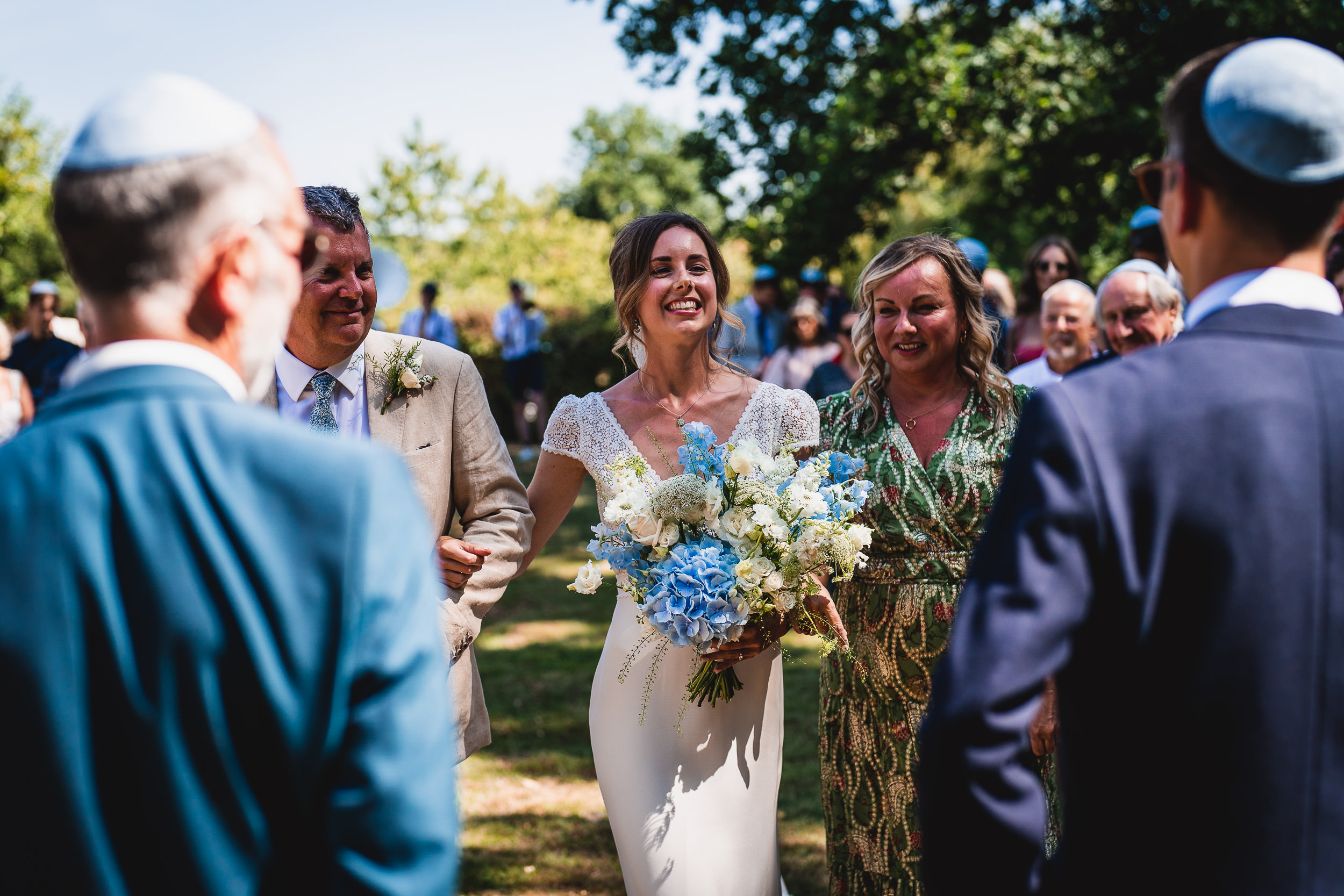 A bride and groom capturing a beautiful wedding photo during an outdoor ceremony.