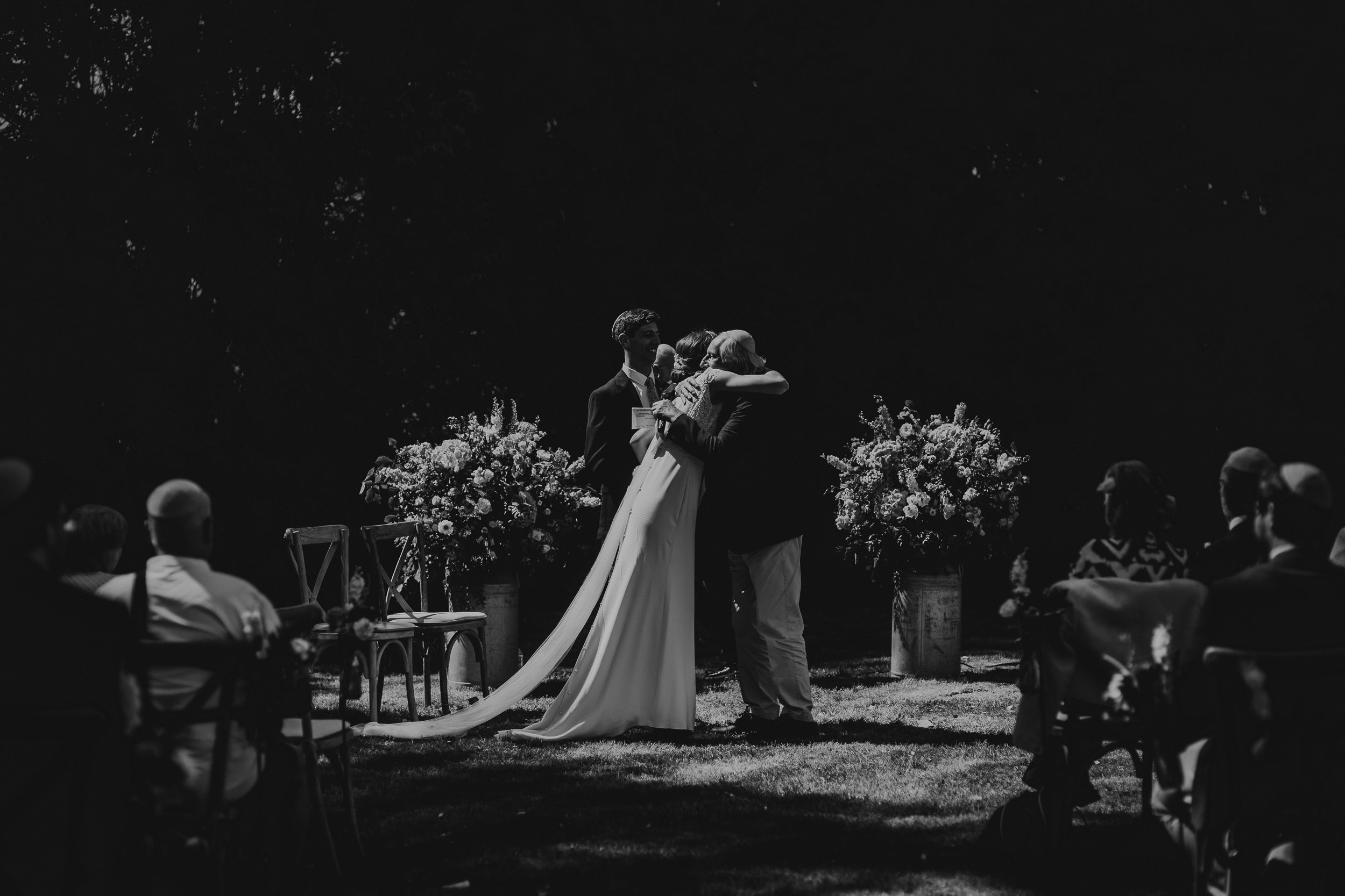 A wedding photo capturing the bride and groom intimately kissing.