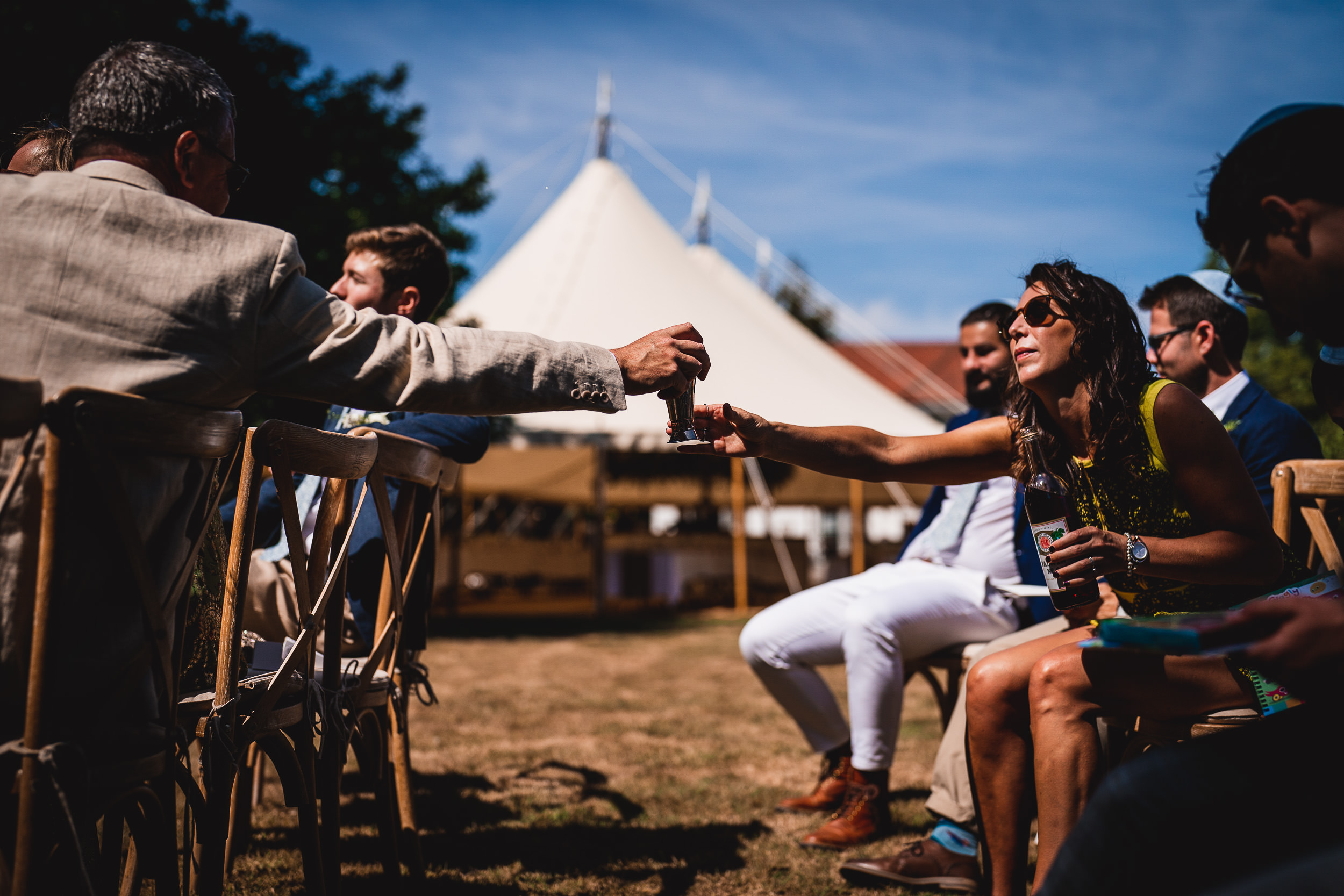 A groom and bride exchange vows in a wedding photo.