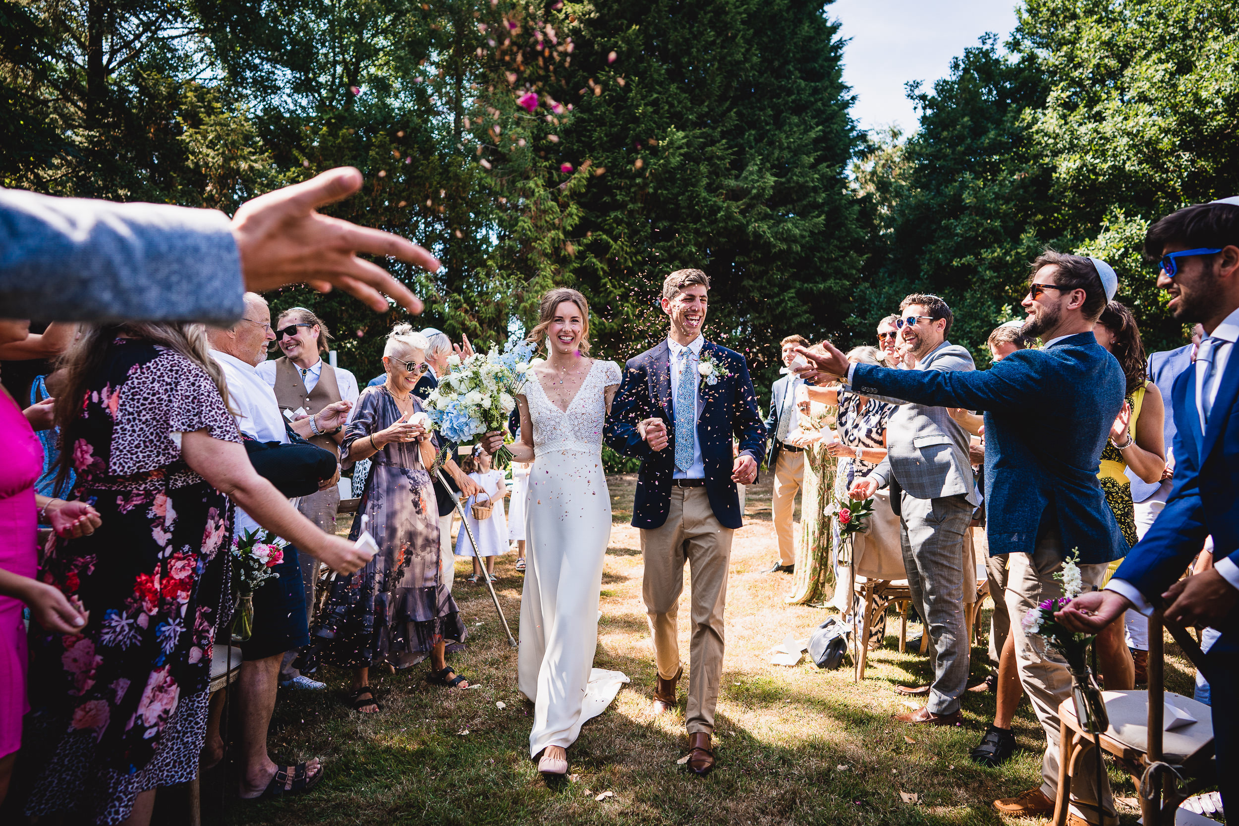 A wedding ceremony featuring a bride and groom walking down the aisle.