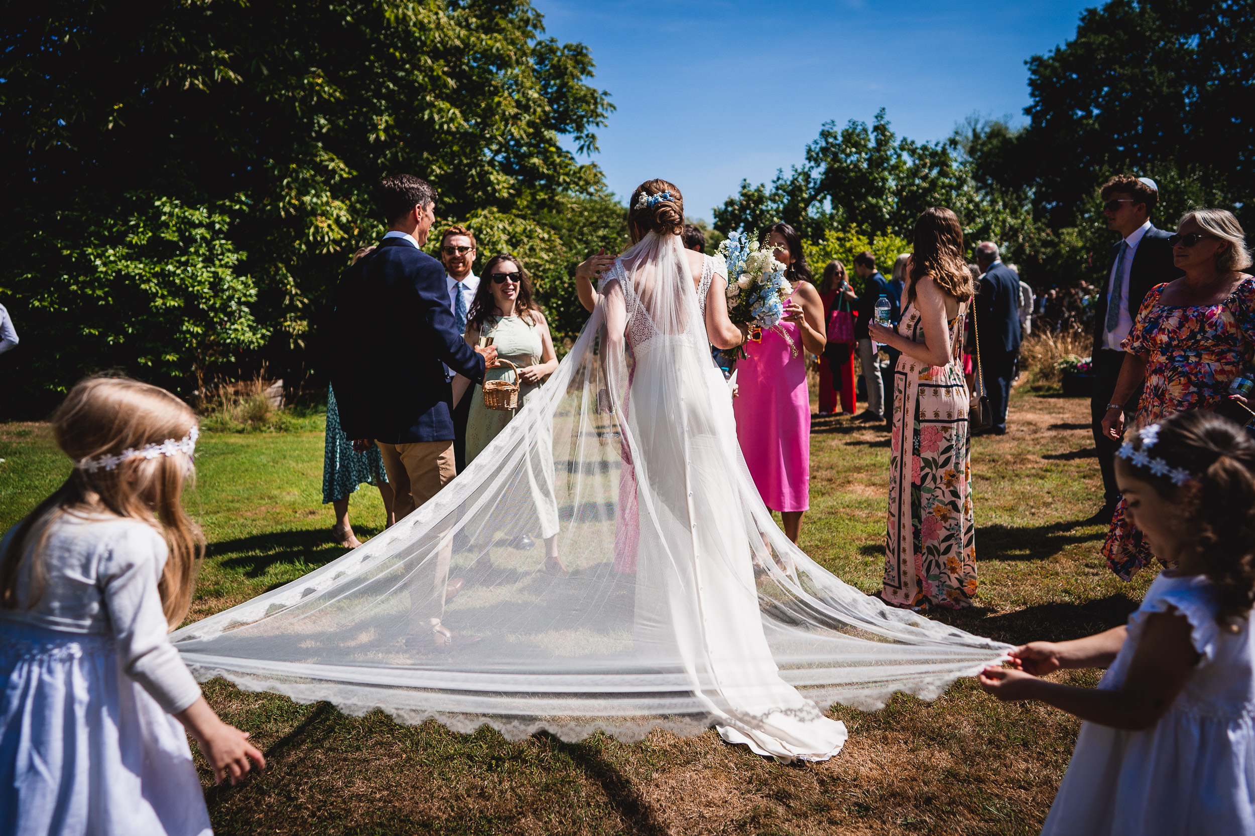 A bride is photographed with her groom during their wedding ceremony.