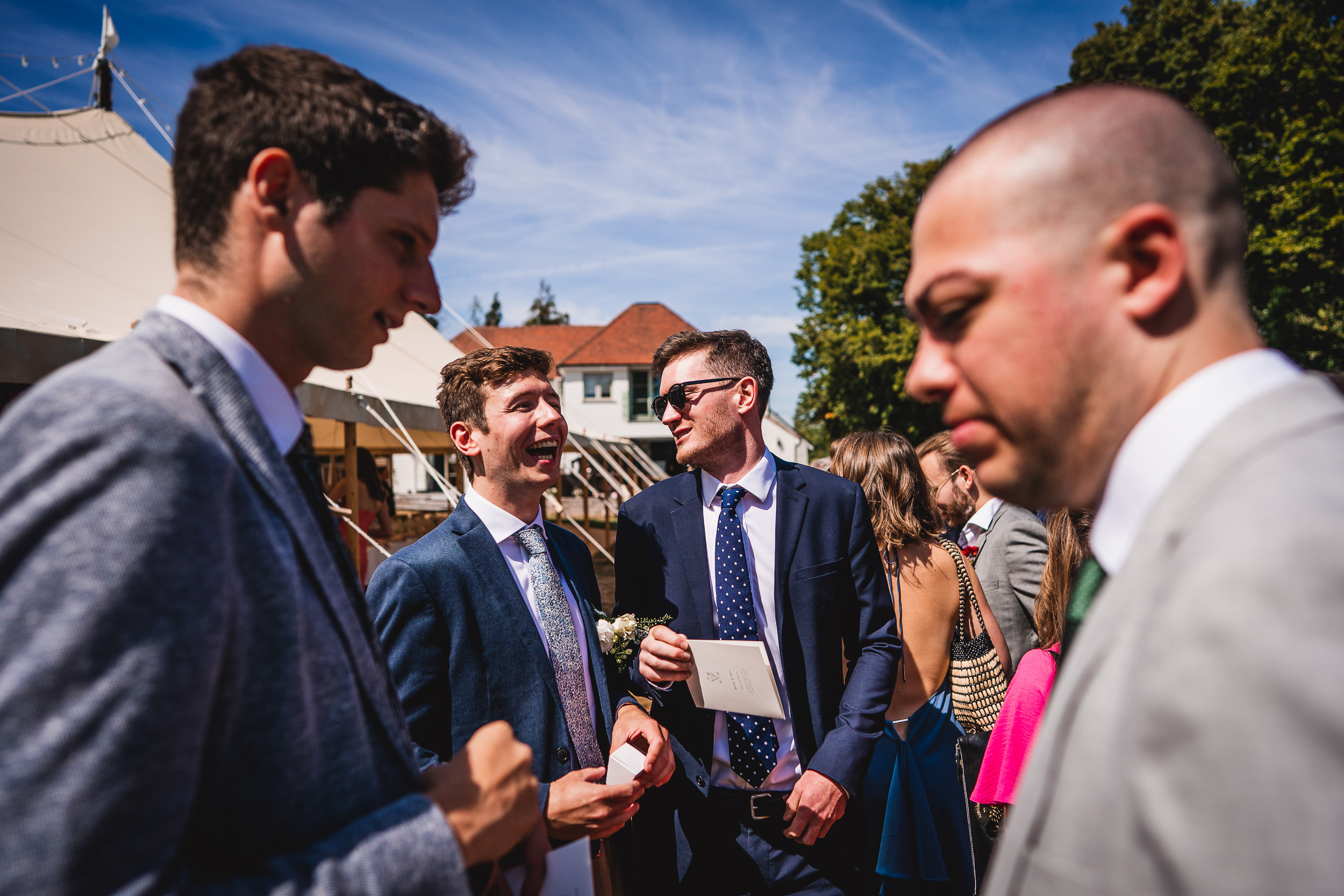 A group of men in suits posing for a wedding photo.