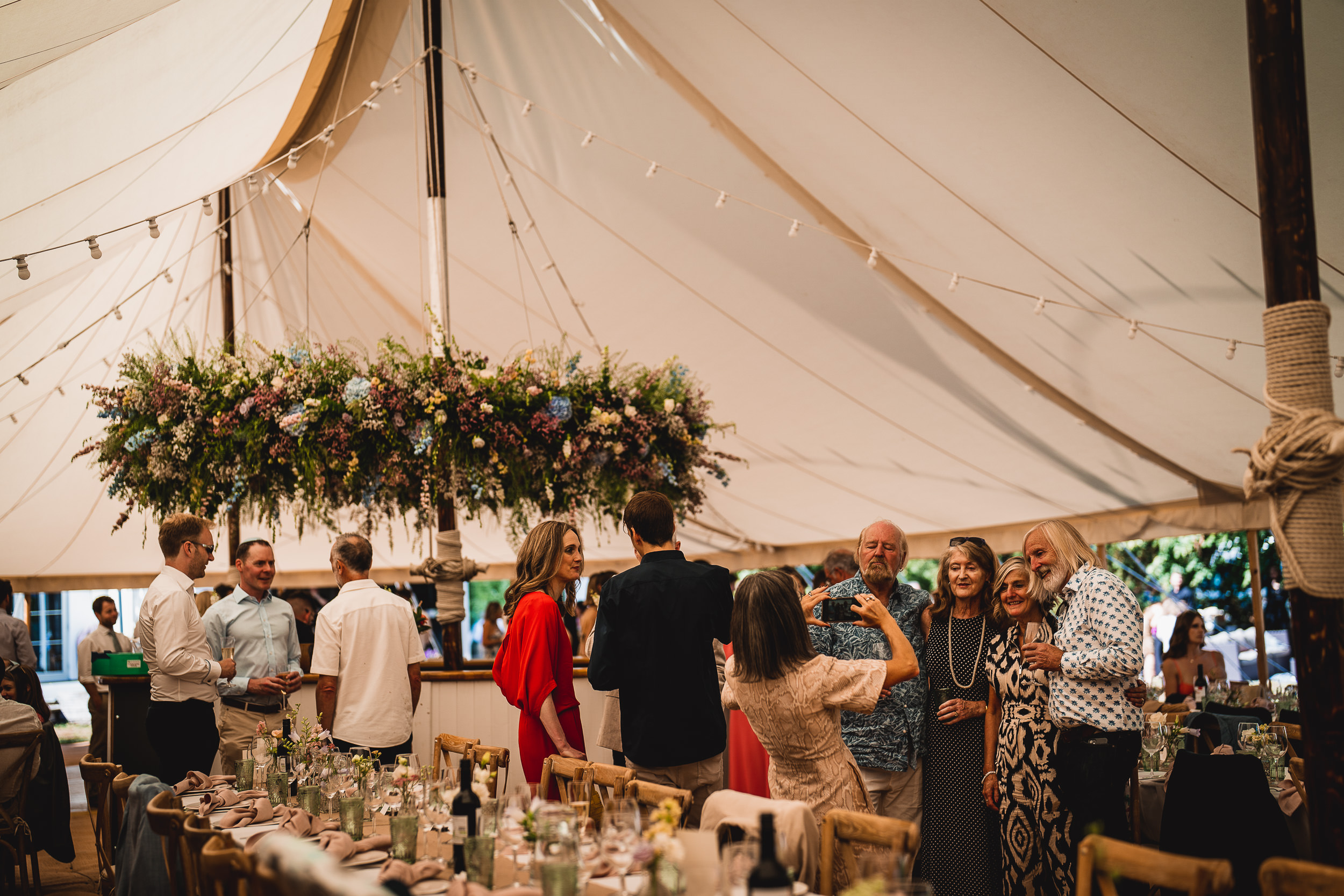 A wedding reception with tables and chairs in a tent.
