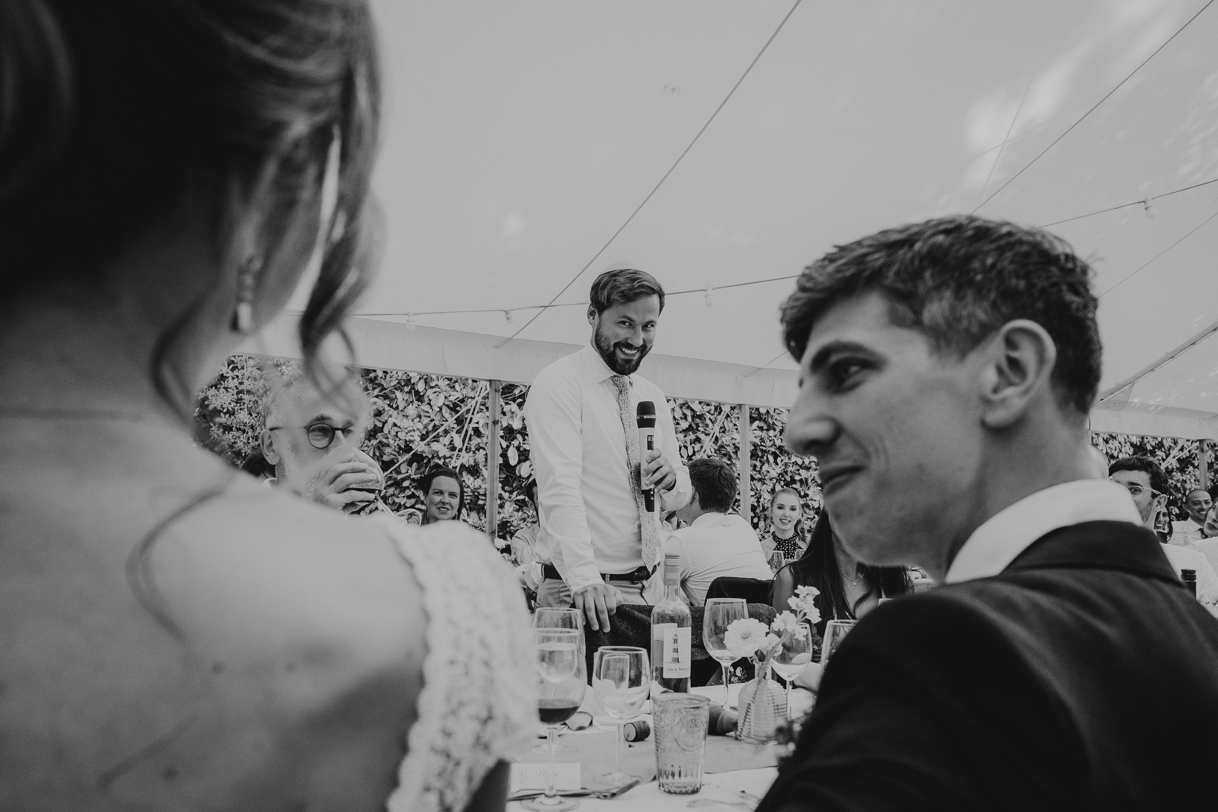 A monochrome groom at a wedding.