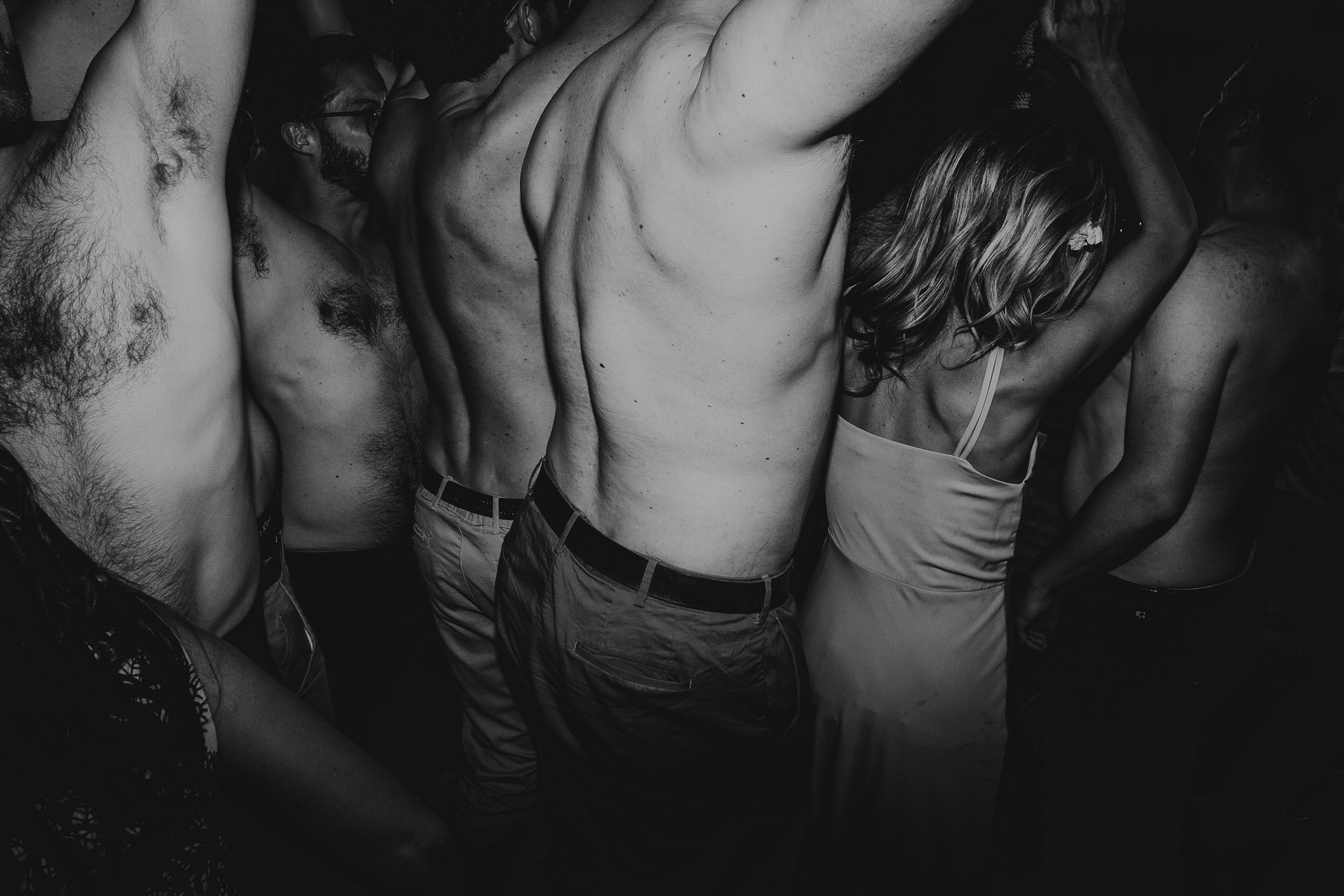 A black and white photo of a group of people at a wedding party.