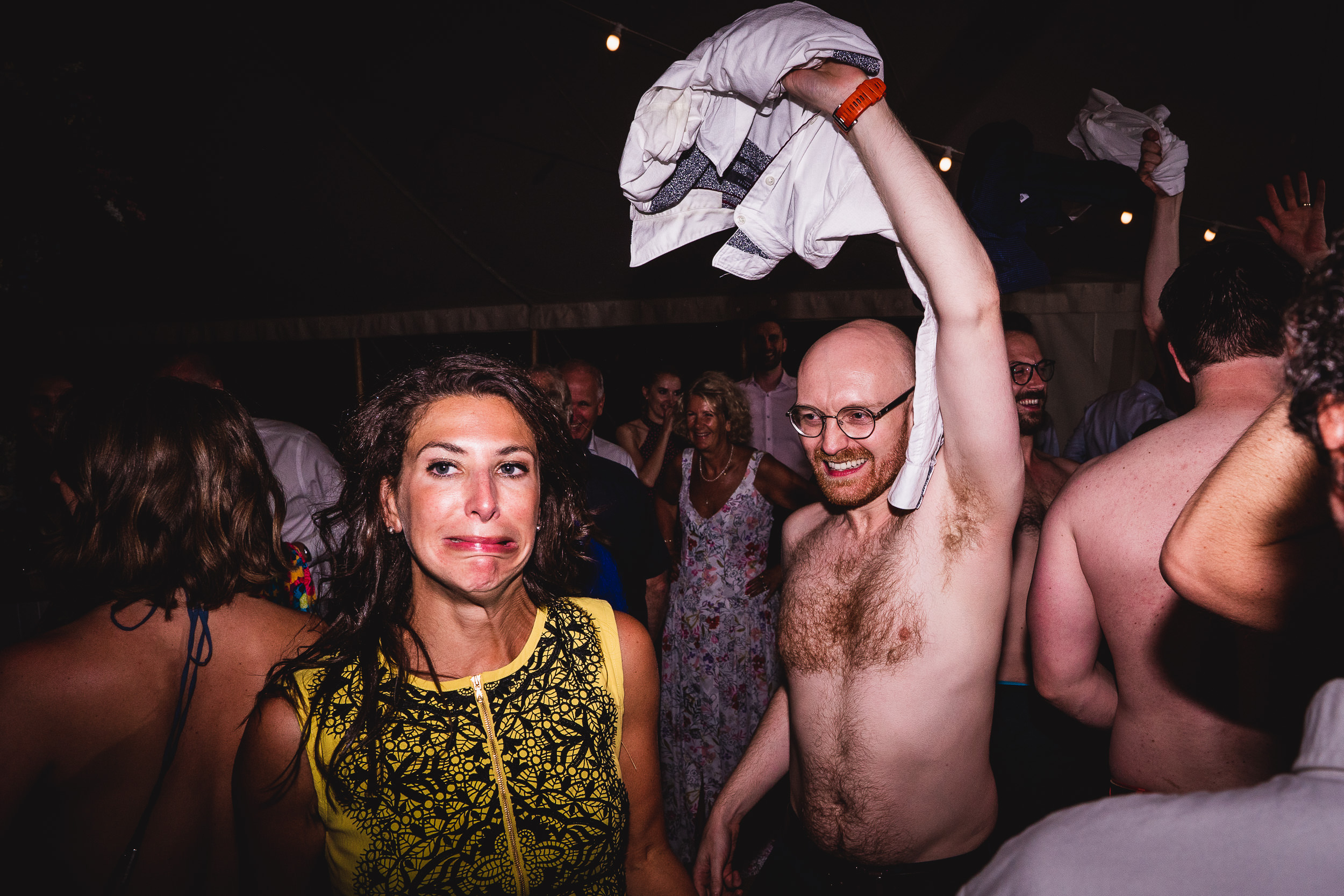 A group of people at a wedding party with a bride wearing a shirt, captured by the wedding photographer in a memorable wedding photo.