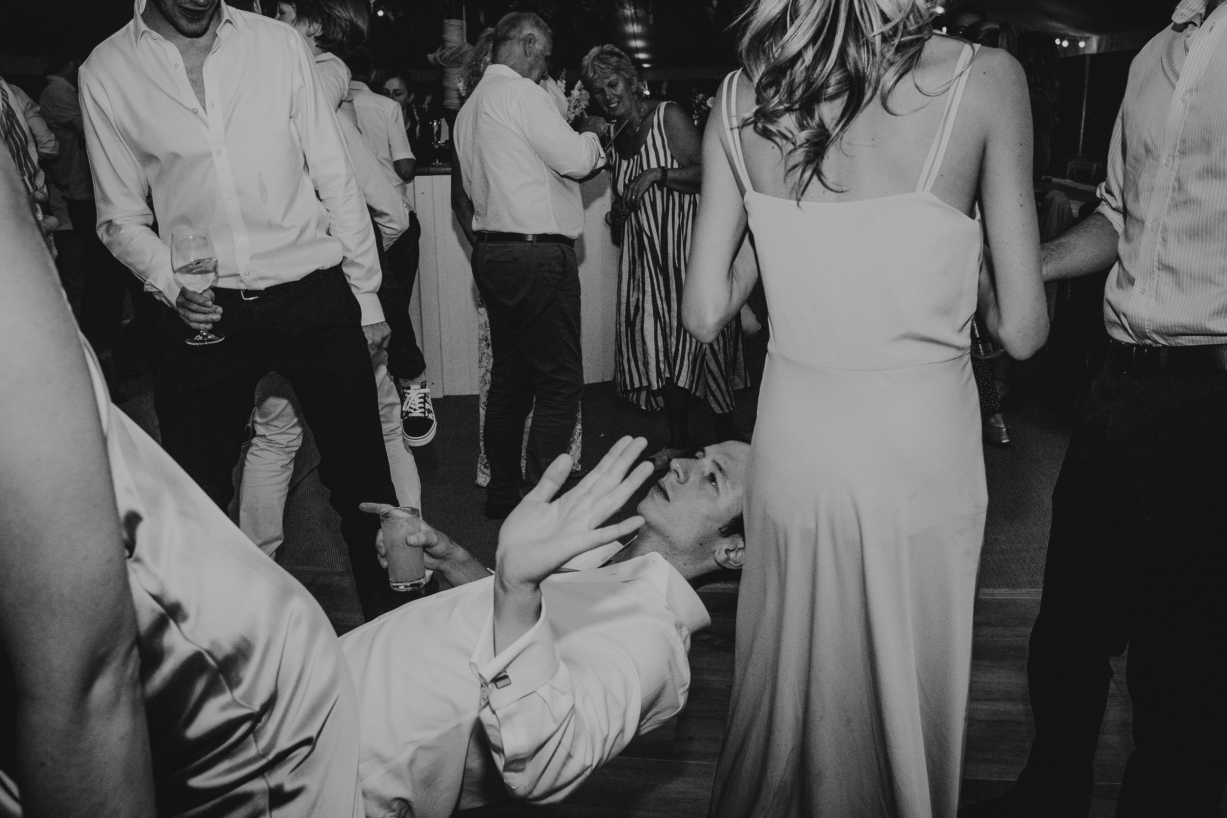 A bride and groom gracefully dance, captured by a wedding photographer.