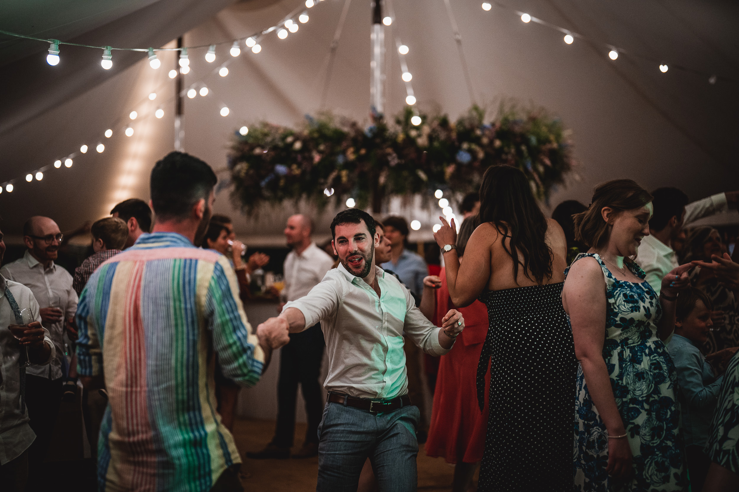 A group of people dancing at a wedding.