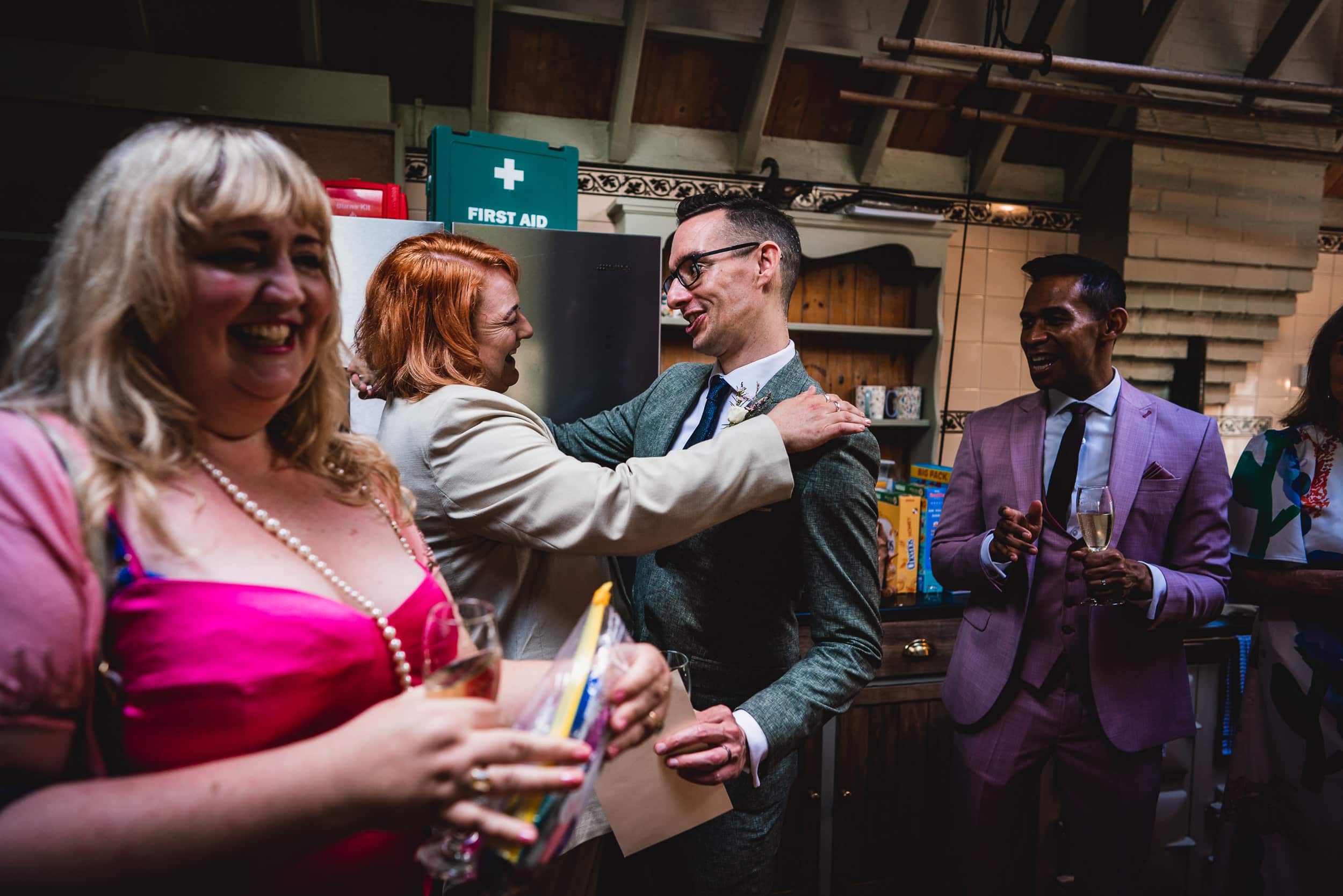 A man is hugging a woman at a Surrey wedding reception.