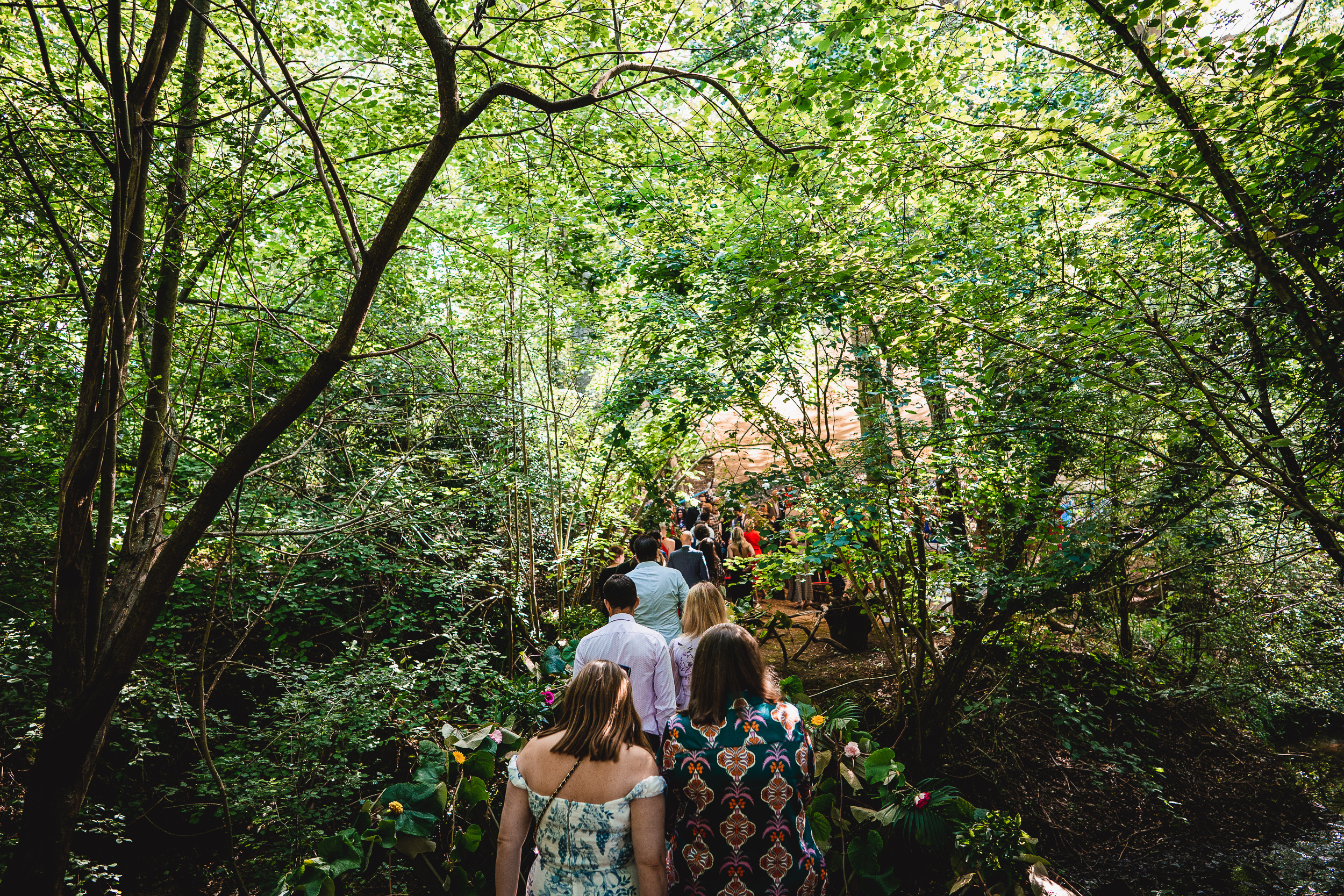 A group of people walking down a path in Surrey Wedding.