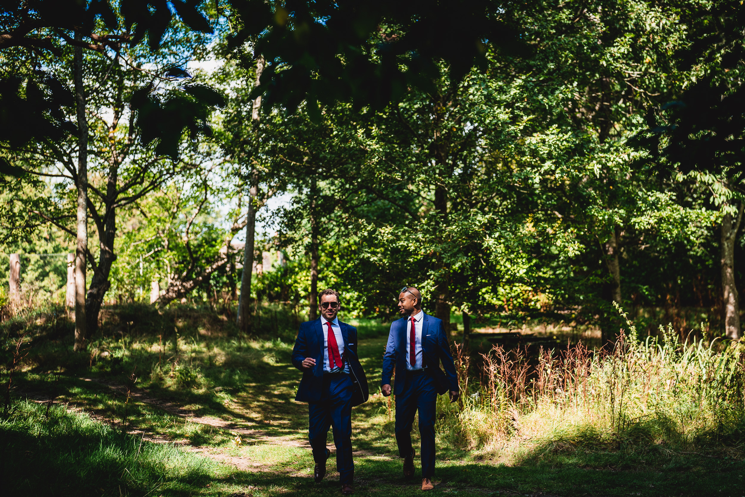 Two men in suits walking down a path at Ridge Farm.
