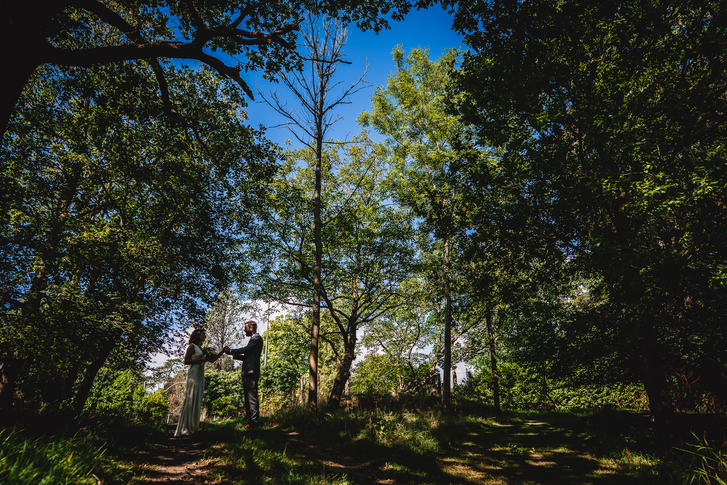 A Surrey wedding couple standing in the woods at Ridge Farm.