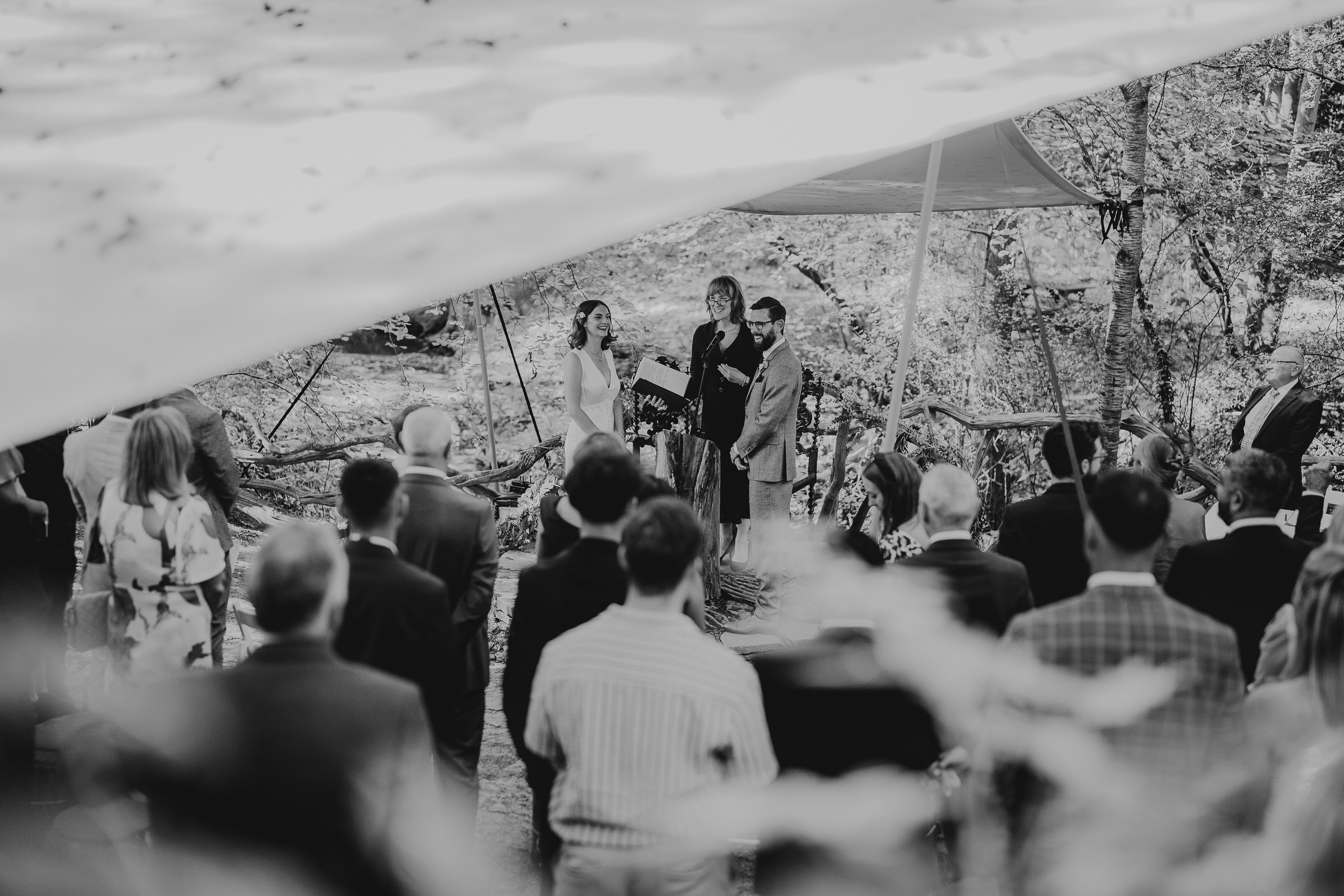 A Surrey Wedding ceremony in the woods at Ridge Farm, captured beautifully in a black and white photo.