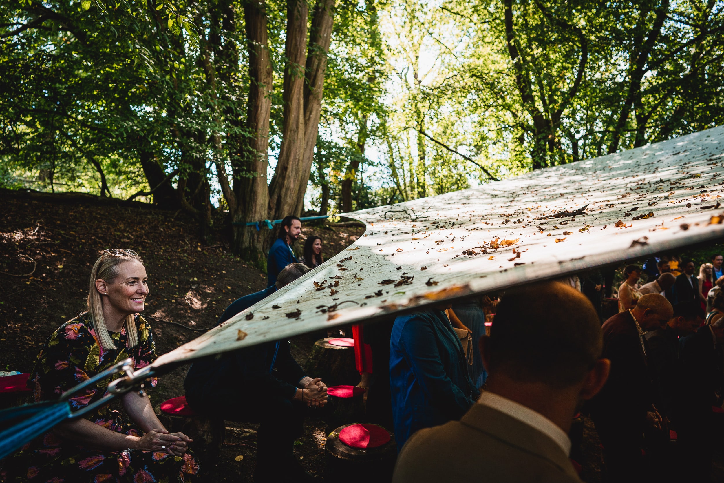 A bride and groom standing under a tent at Ridge Farm for their Surrey wedding in the woods.