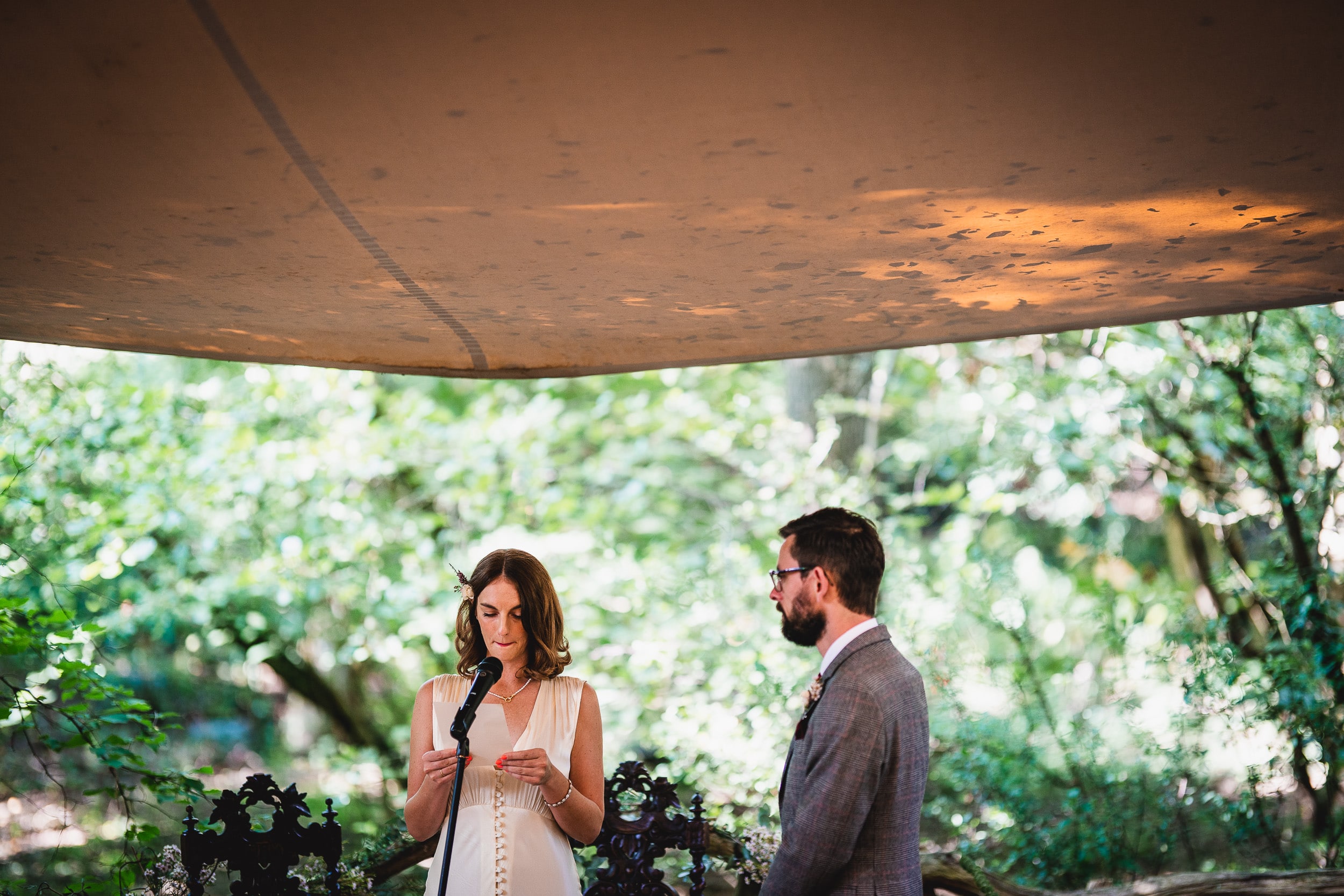 A Surrey Wedding bride and groom standing in front of a tent at Ridge Farm.