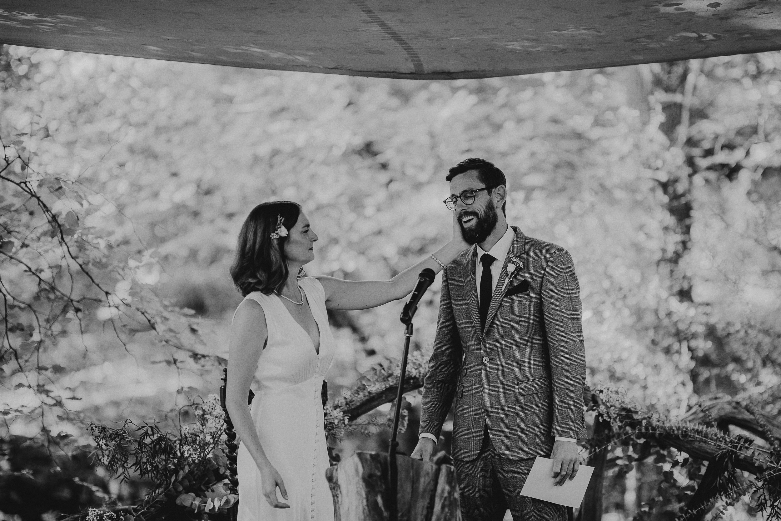 Black and white photo of a bride and groom at their wedding ceremony in Ridge Farm, Surrey.