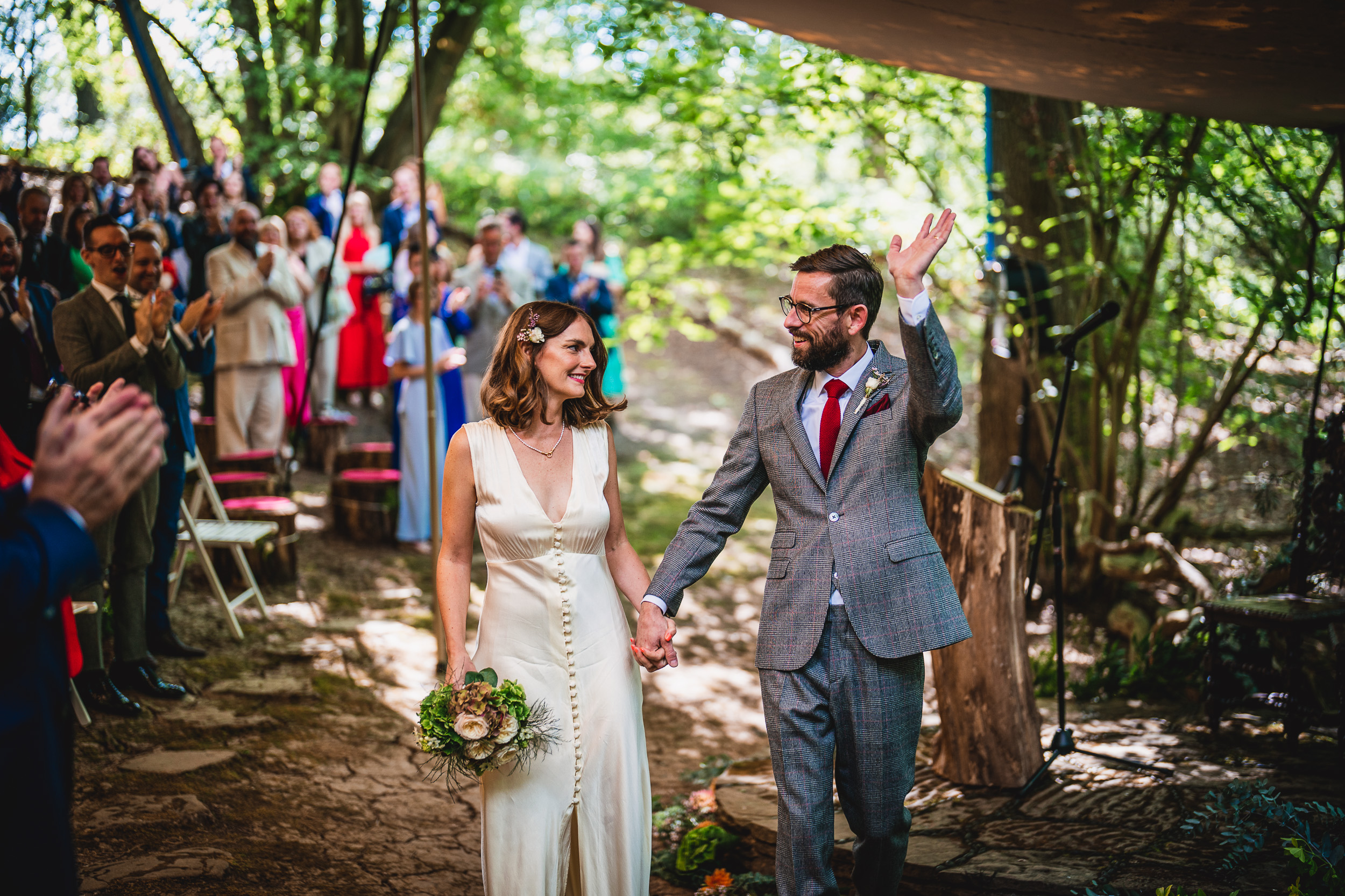 The Ridge Farm bride and groom joyfully walk down the aisle at their Surrey outdoor wedding.