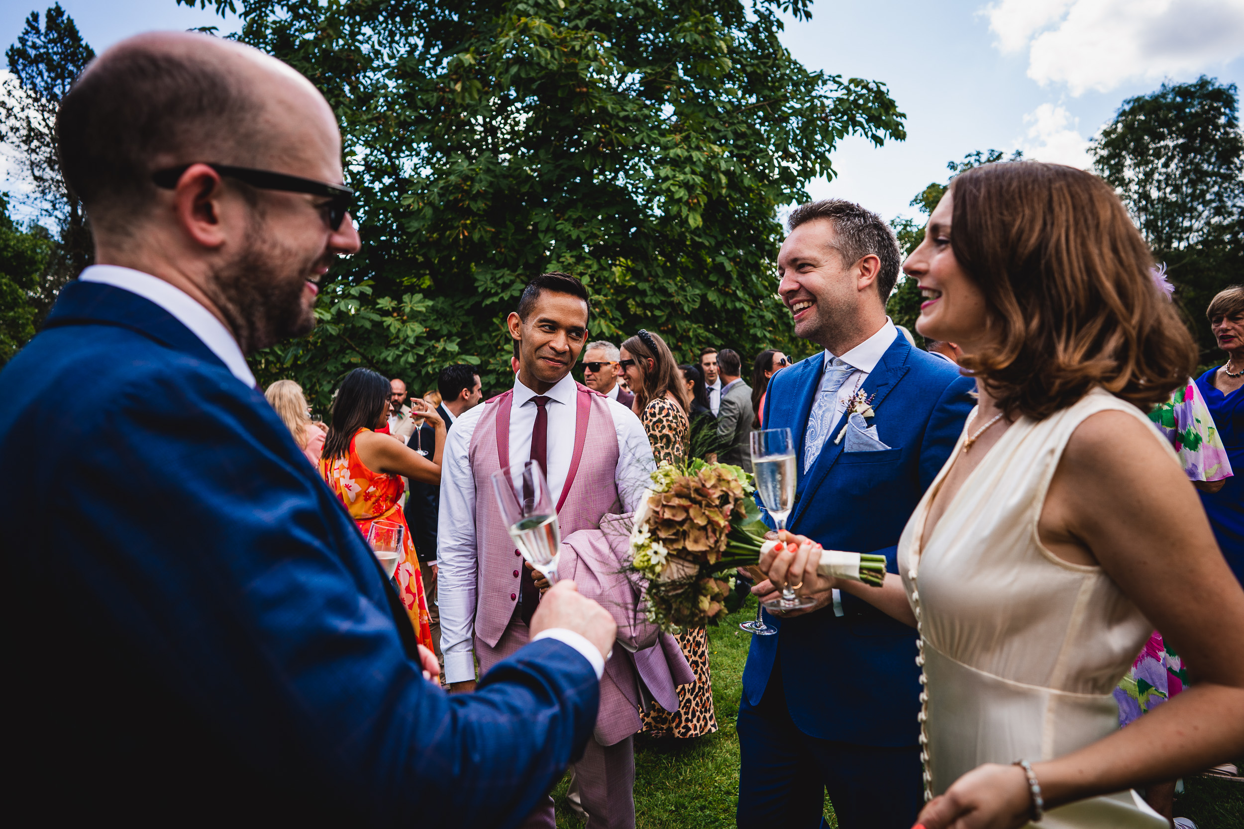 A Ridge Farm wedding, with the bride and groom sharing a heartfelt conversation amidst the joyous occasion in Surrey.