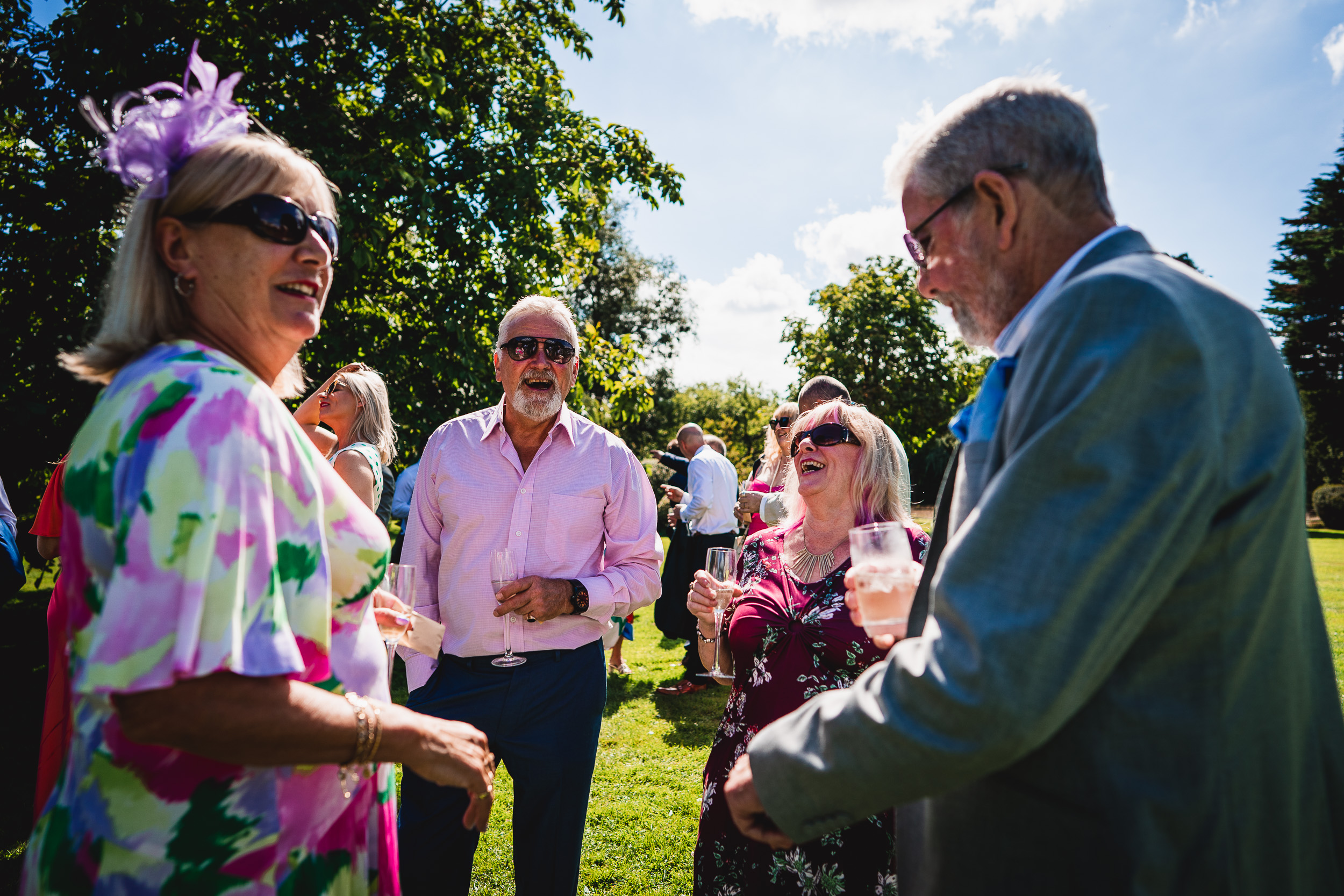A group of people talking to each other at an outdoor Surrey Wedding event.