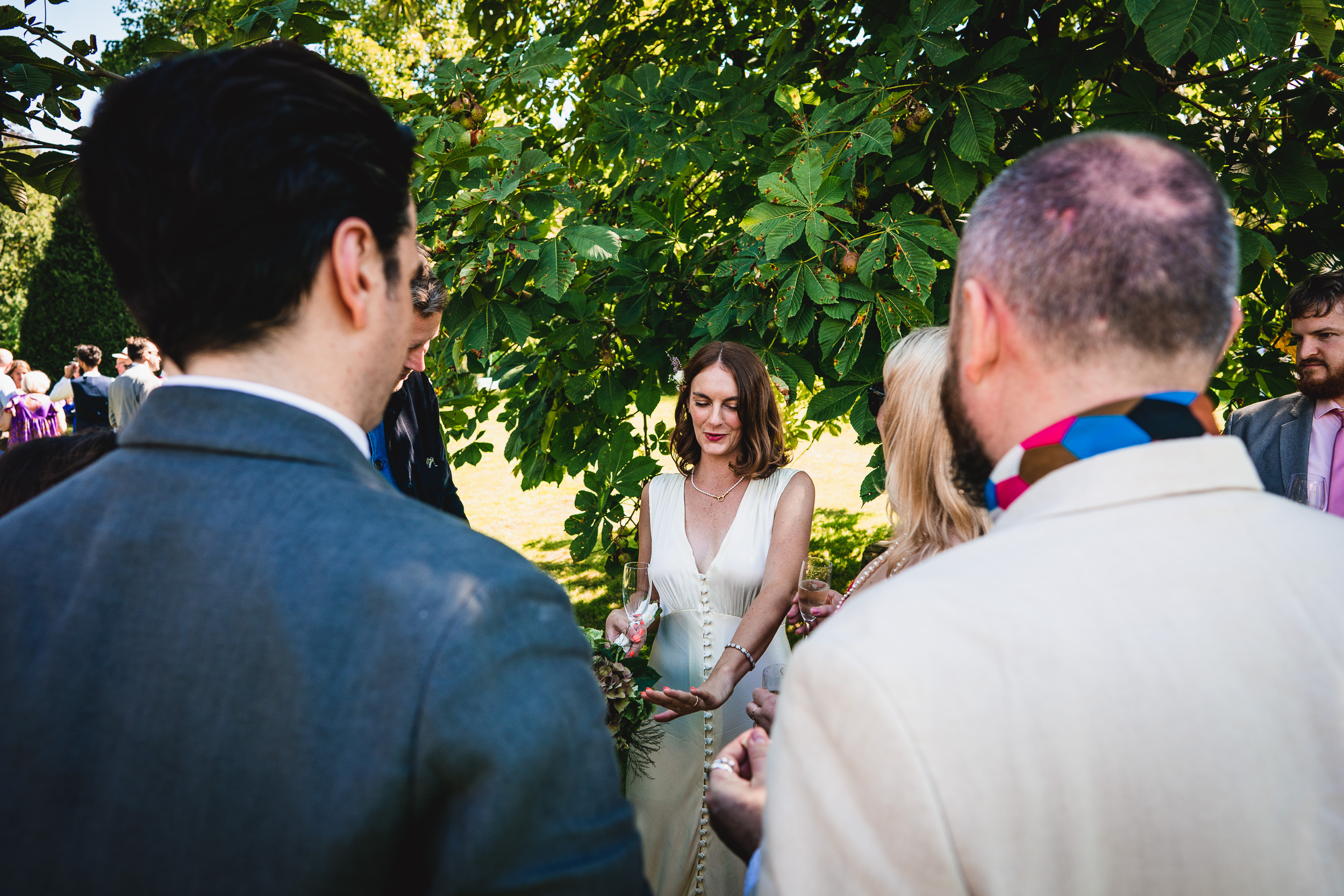 A Ridge Farm bride and groom standing in front of a tree at their Surrey Wedding.