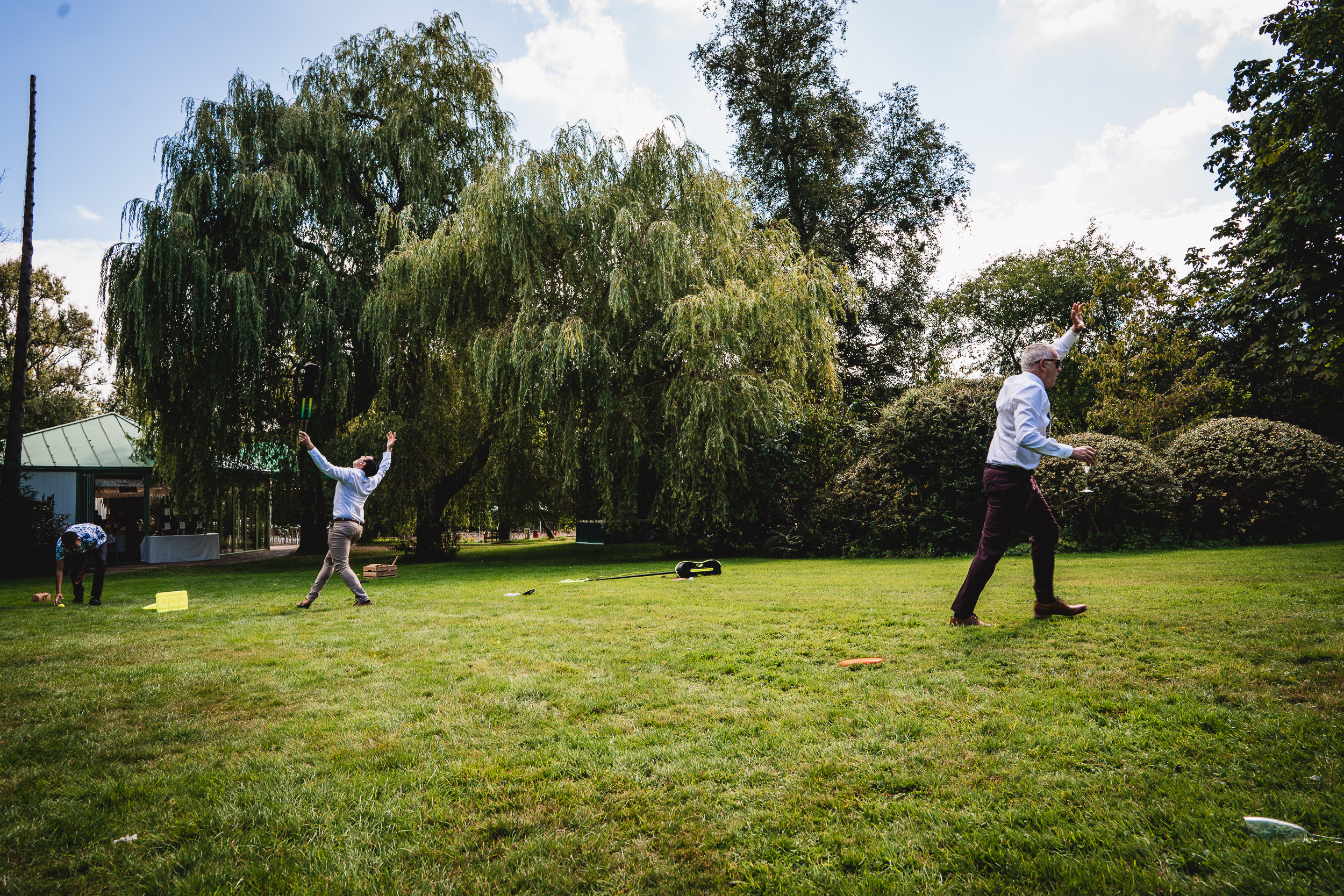 A group of people playing frisbee in a park.