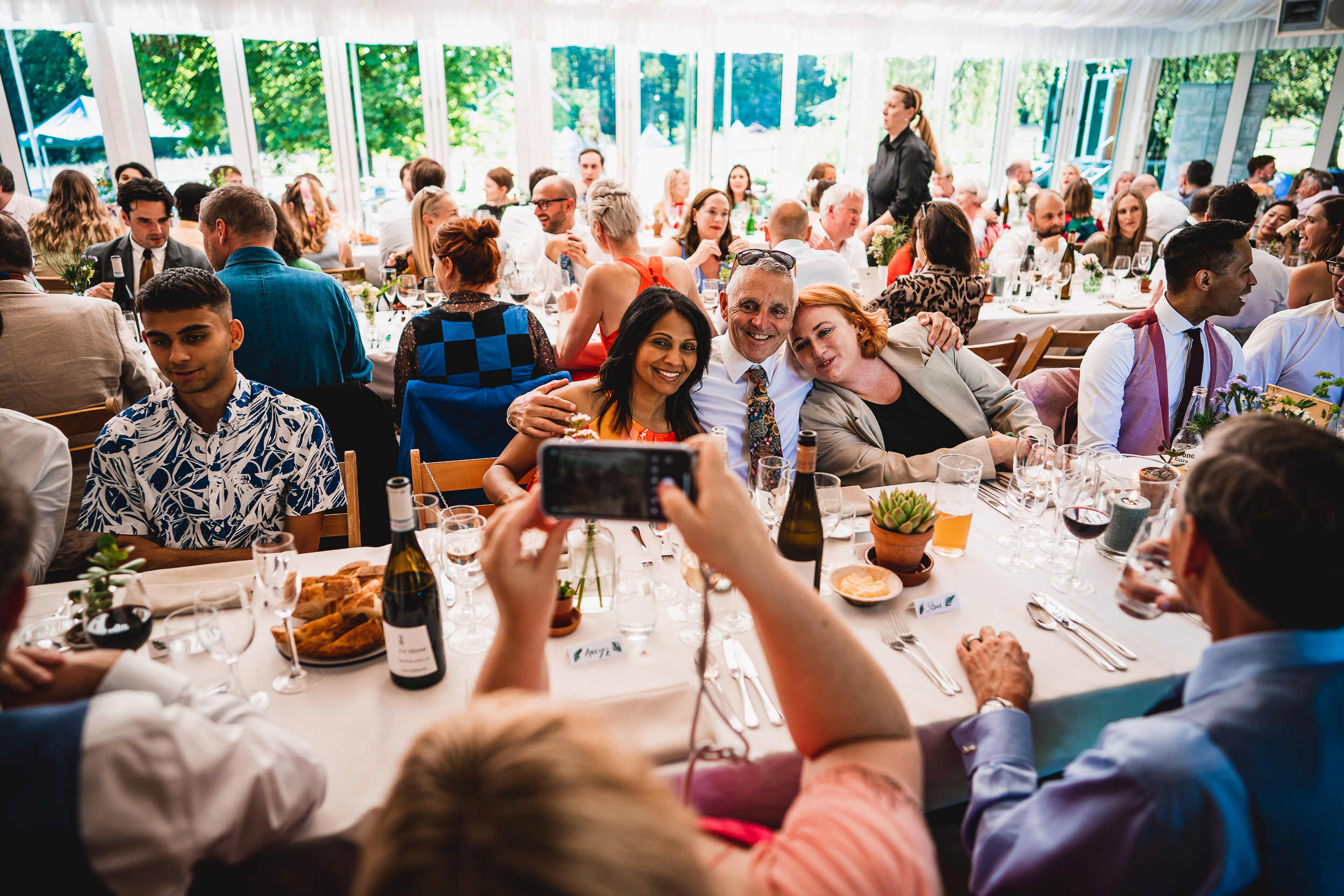 A group of people taking pictures at a Surrey wedding reception.