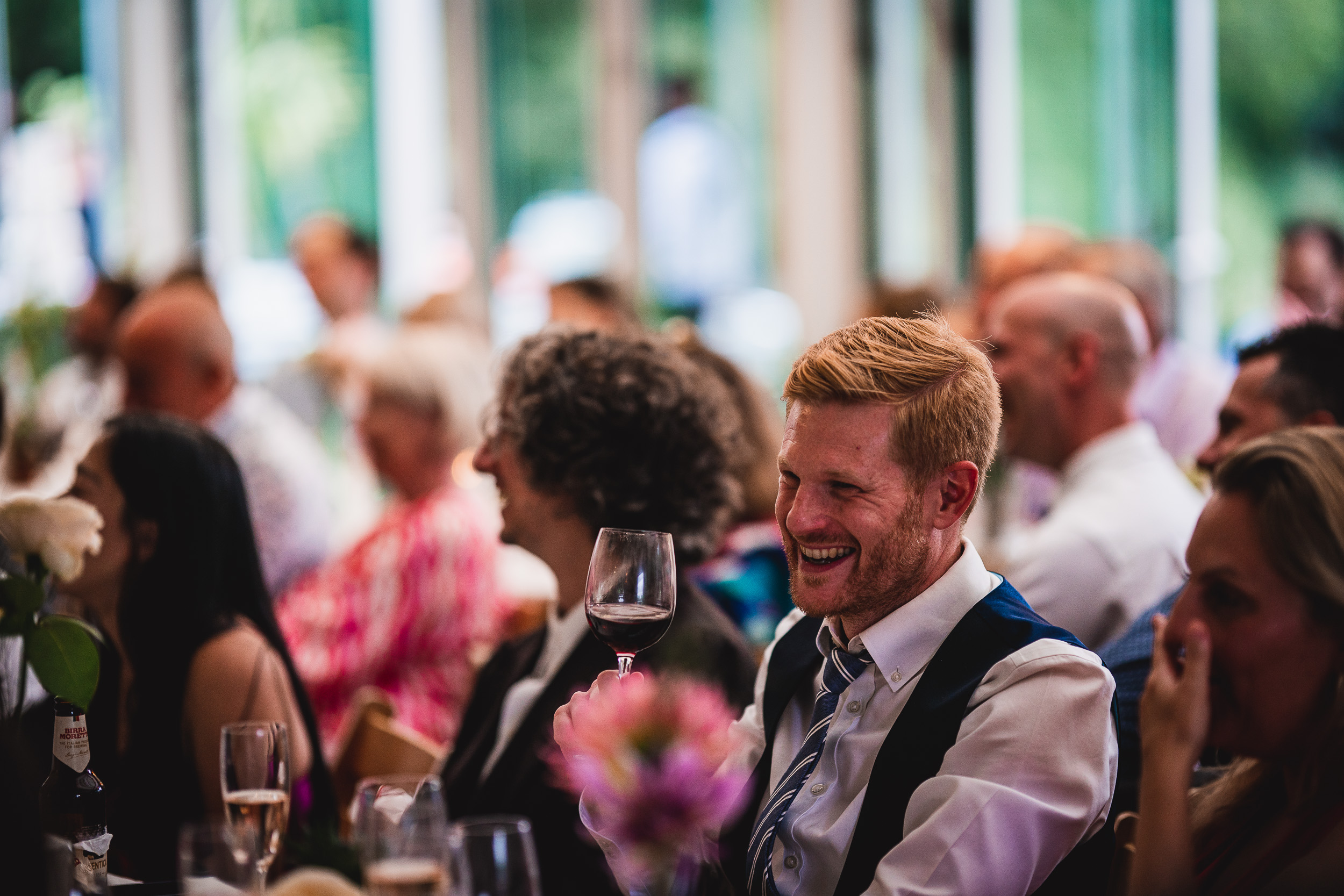 A man laughing at a Surrey wedding reception at Ridge Farm.