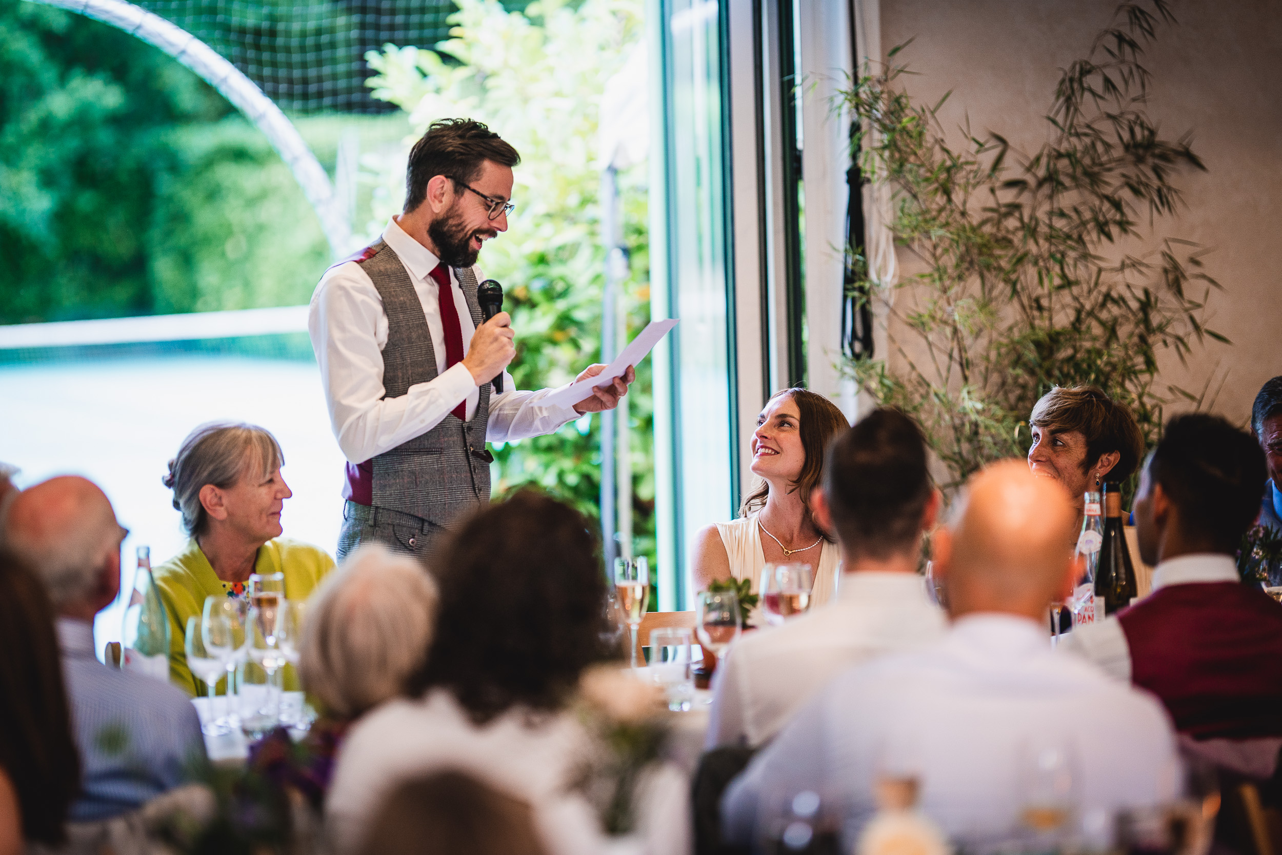 A man giving a speech at a Surrey Wedding reception.