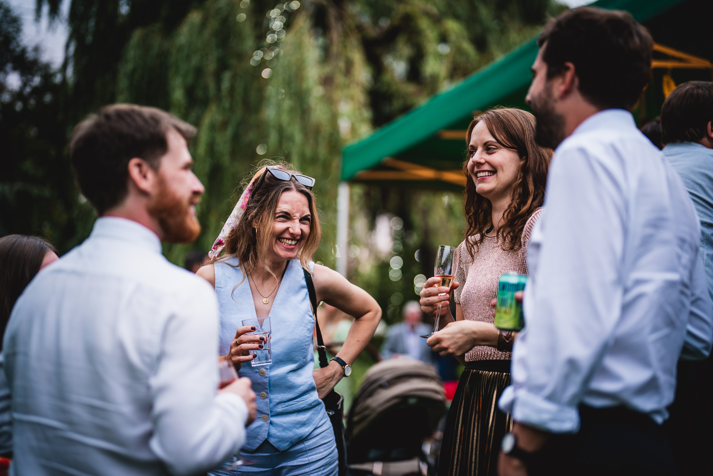 A group of people enjoying Surrey Wedding at an outdoor event, sipping on wine at Ridge Farm.