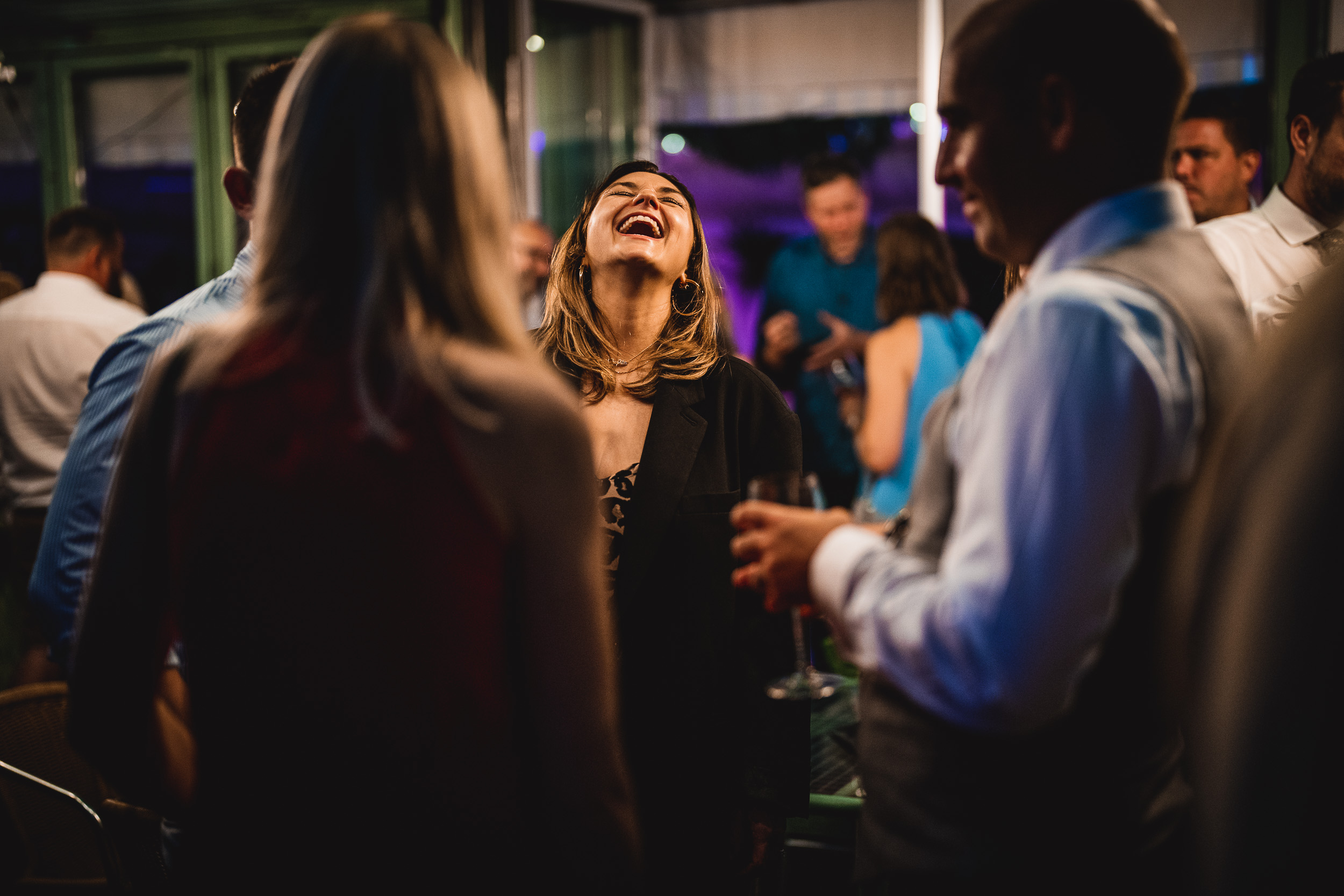 A group of people laughing at a Surrey Wedding party held at Ridge Farm.