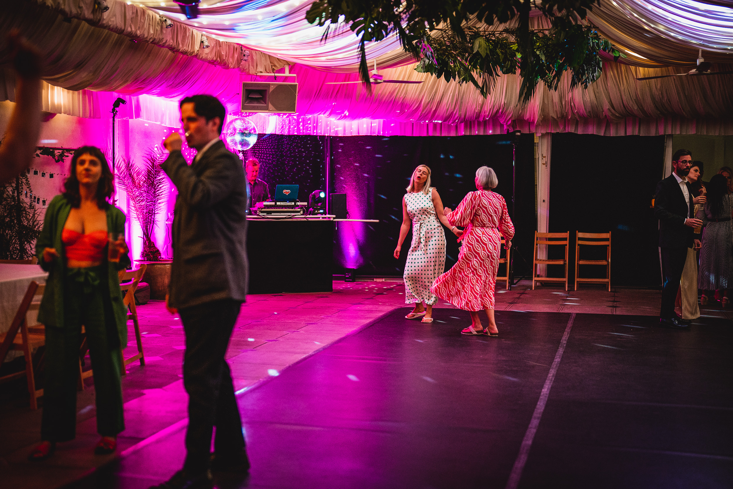 A group of people on a dance floor at a Surrey wedding.