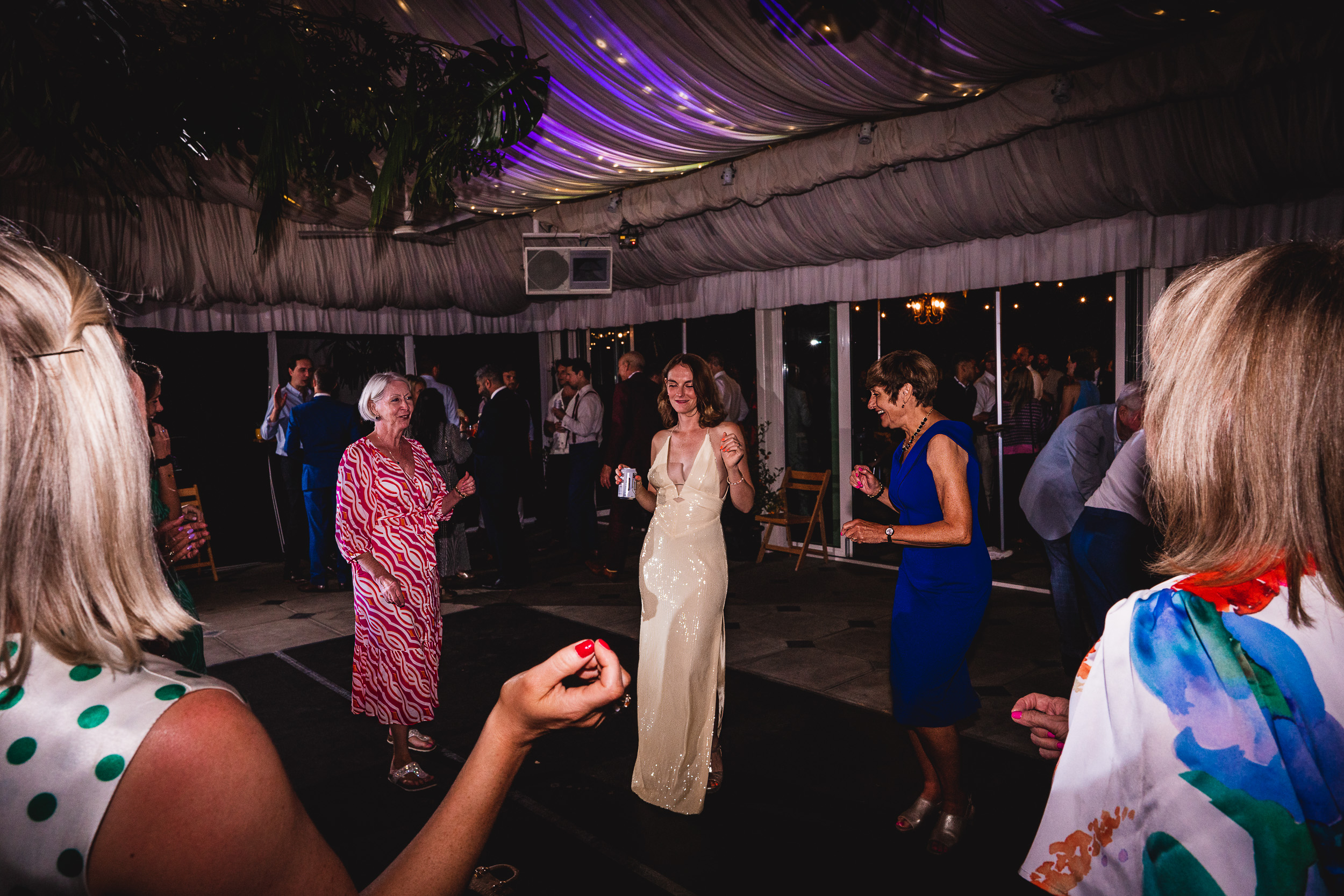 A woman dancing on the dance floor at a Surrey wedding.
