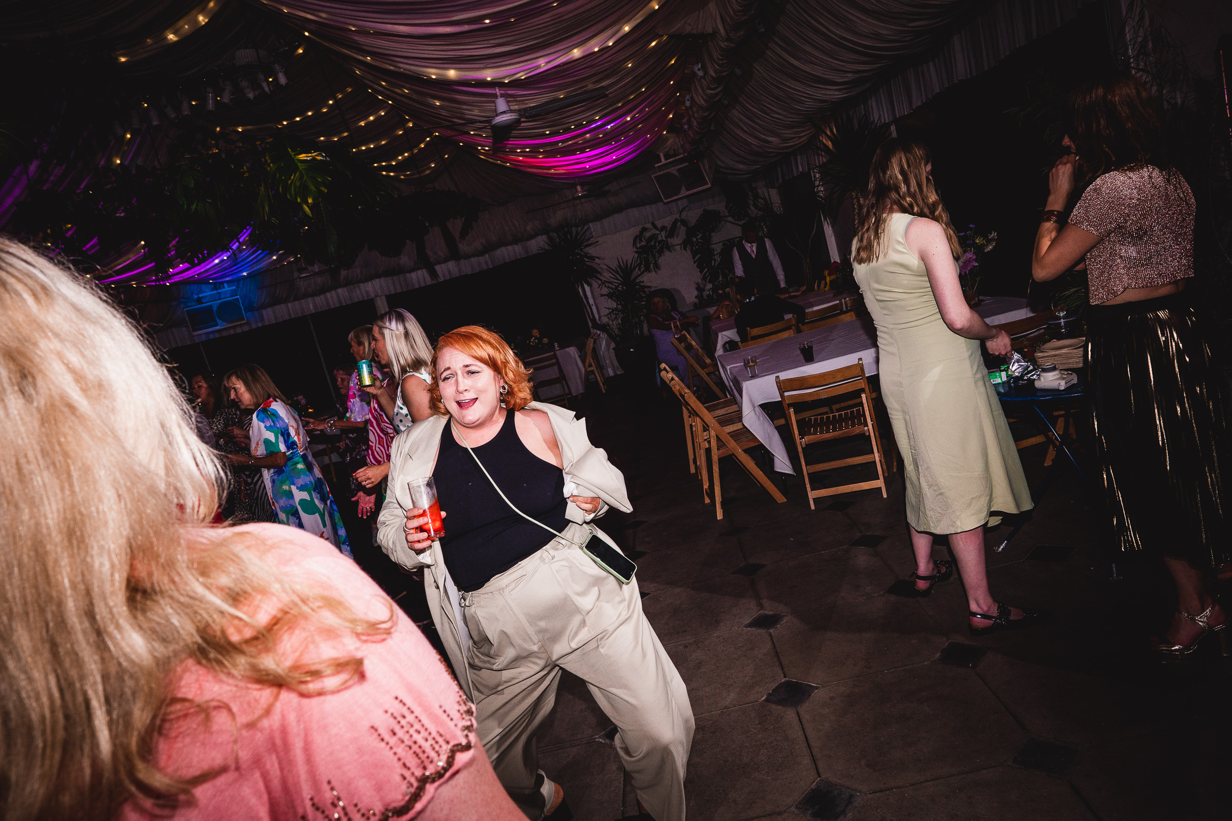 A group of people dancing at a Surrey Wedding party.
